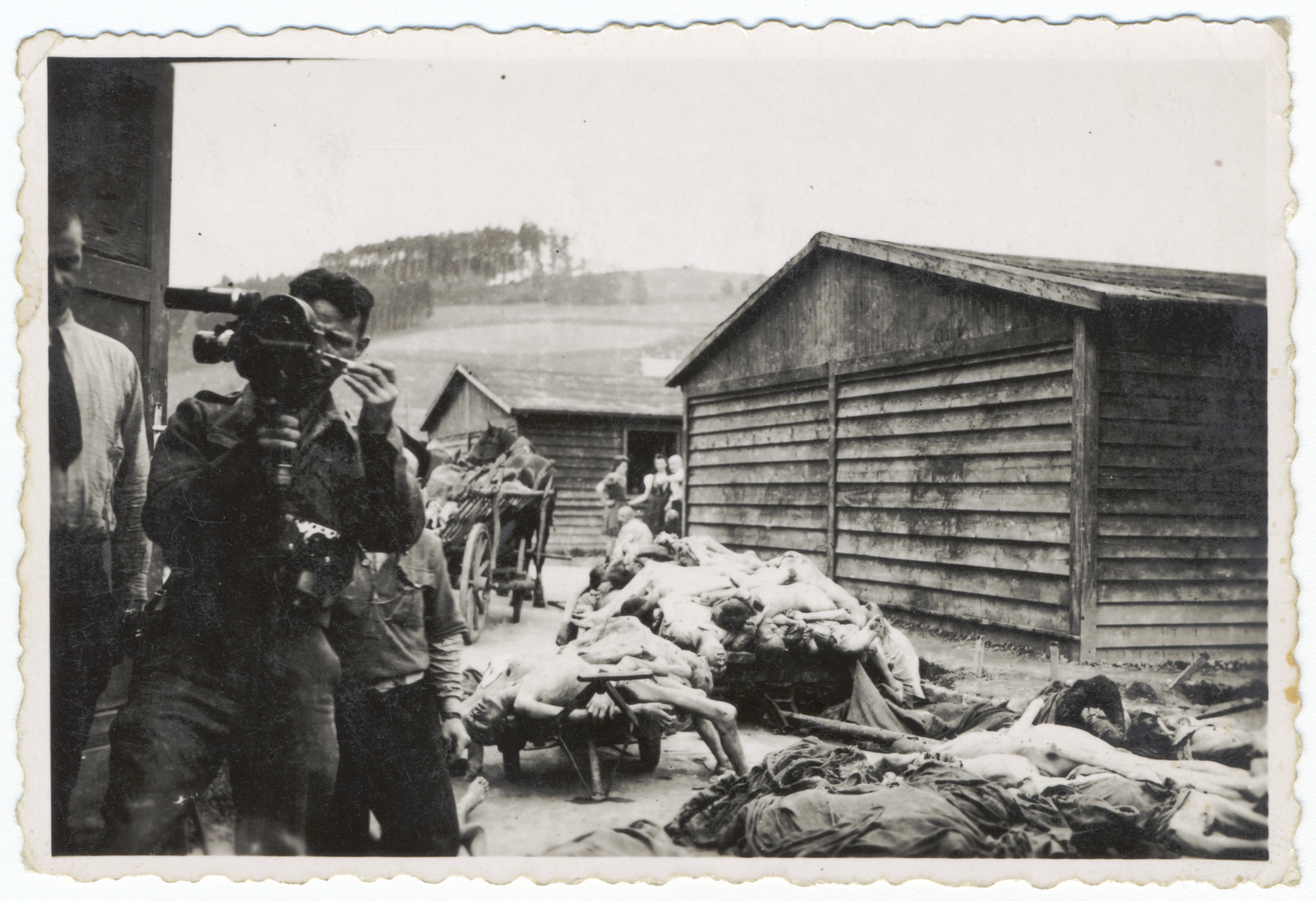 An American signal corps photographer films the clearing of piles of corpses in the Gusen concentration camp.