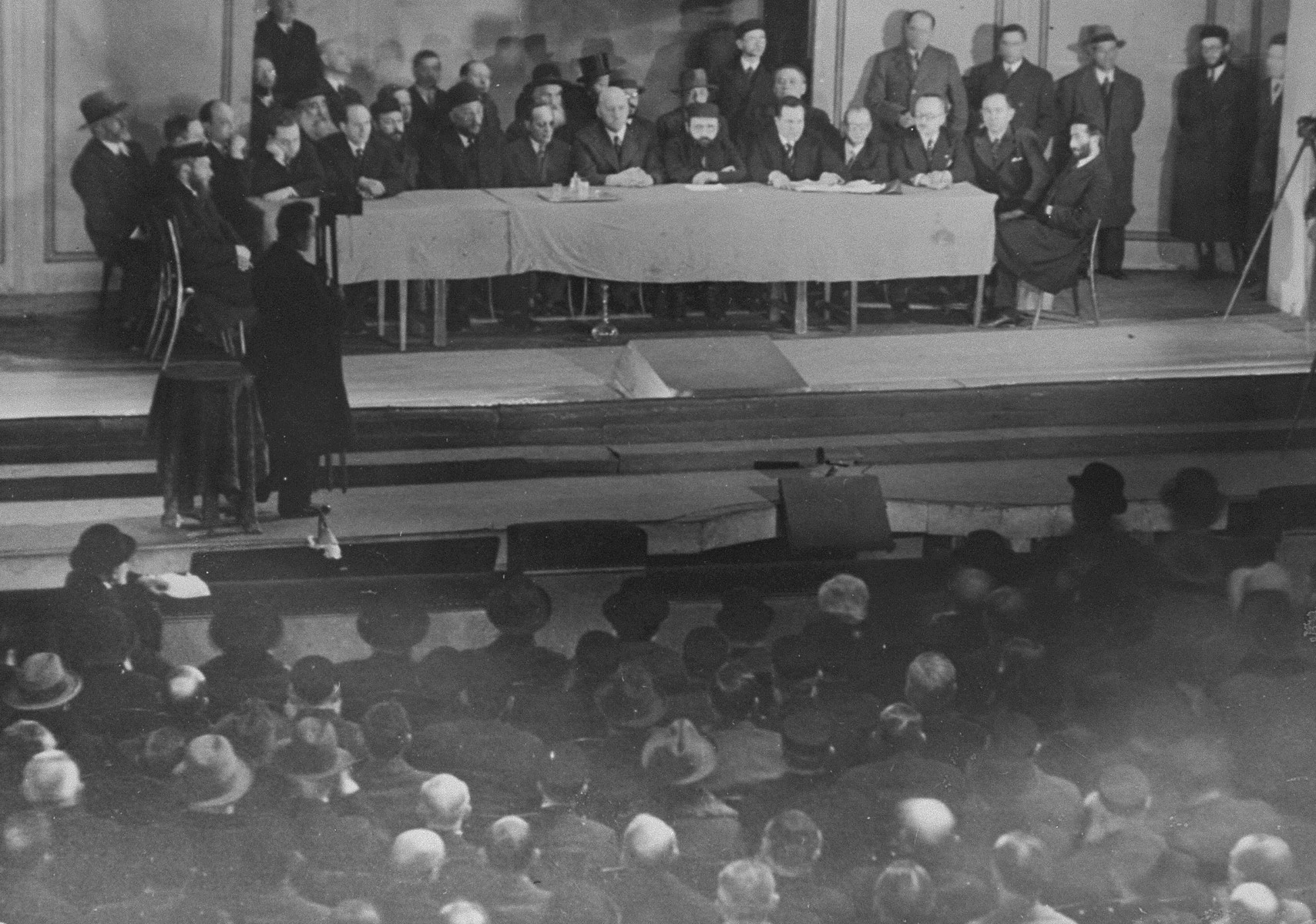View of the speakers' podium during a public meeting to protest the enactment of anti-Jewish legislation by the Nazi regime in the Jewish Theater in Warsaw.
