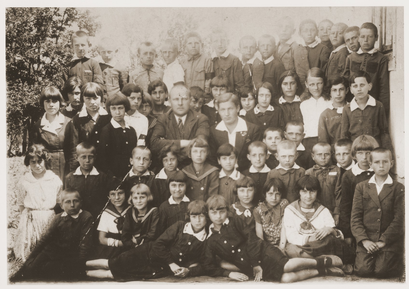 Group portrait of students at the elementary school in Kowel, Poland. 

Nachman Pinsky, the donor's cousin, is seated in the front row, third from the right.