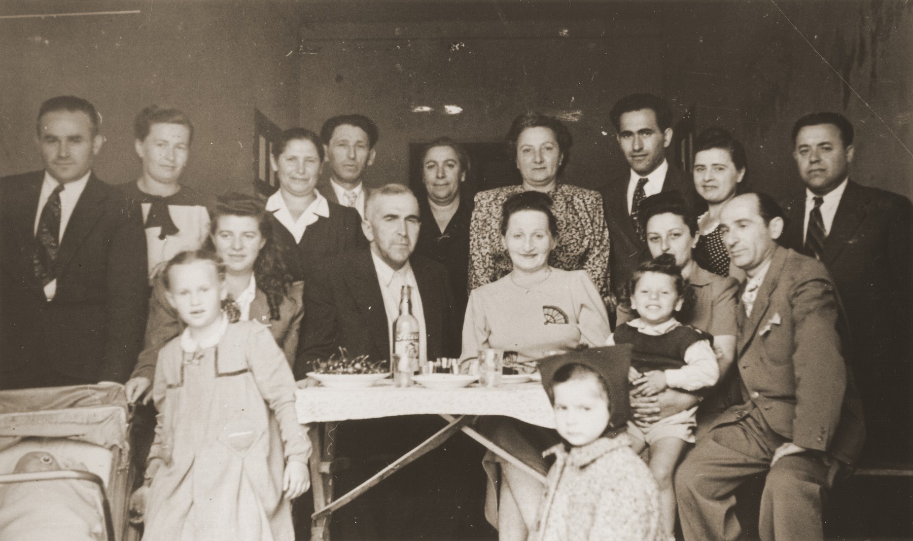 Group portrait of Jewish DPs at a going away party in the Trani displaced persons camp.

Among those pictured are Motel, Zelda and Masha Leikach, Chaim and Chaika Katz, and Aaron Pelc.