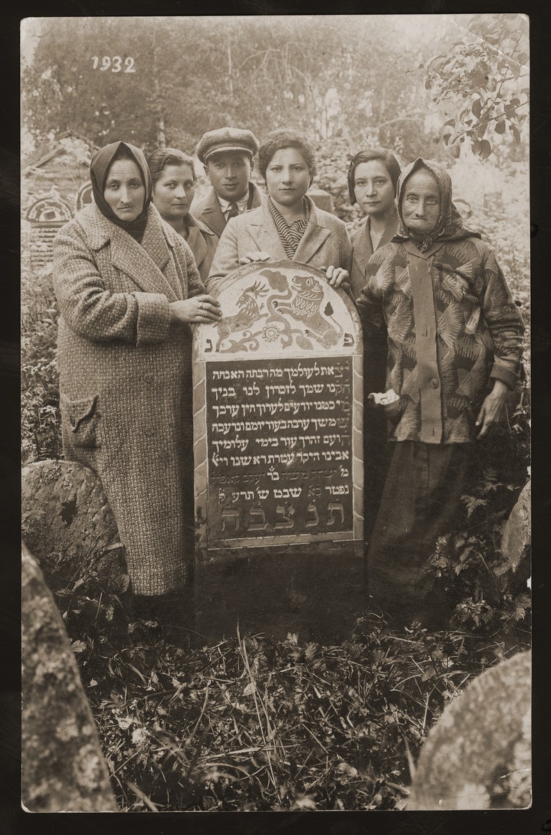 Family members gather around the tomb of Yitzhak Moshe, the son of Yaakov Kapol.