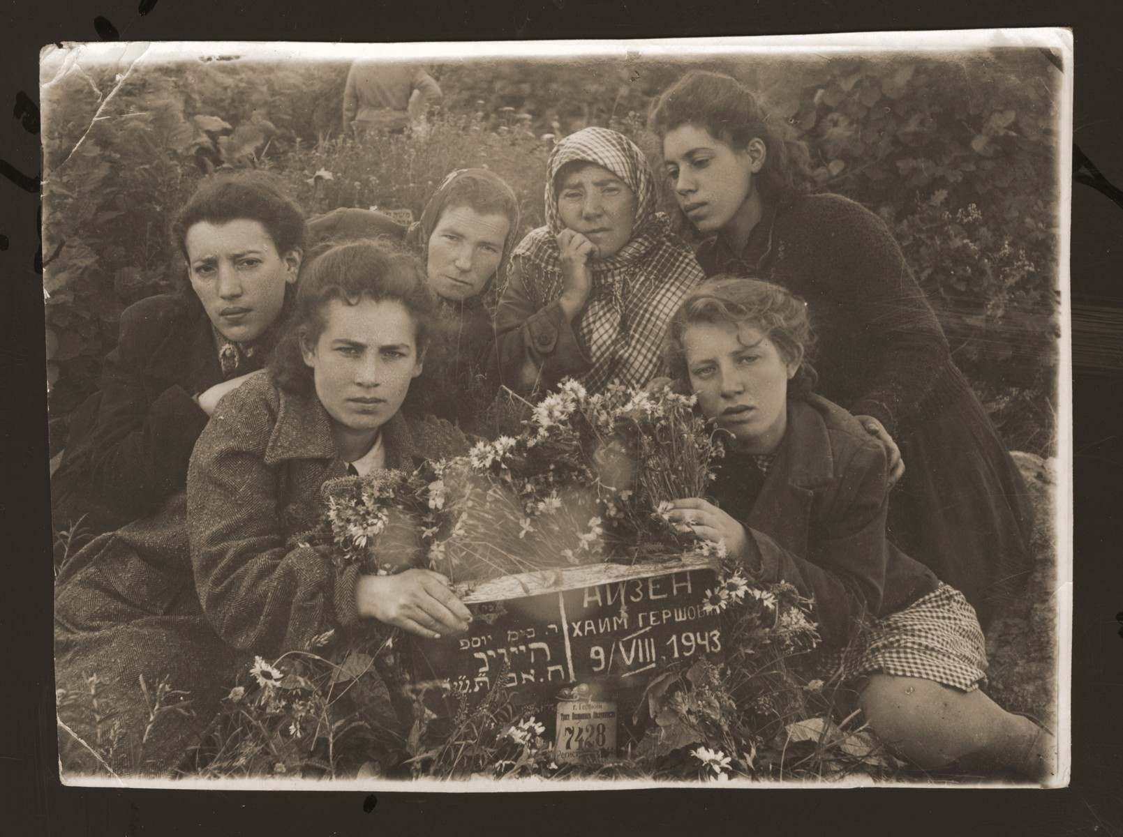 Necha Ajzen poses with her daughters at her husband's grave in Gorky.

Pictured clockwise from the lower left are: Chaika, Mania, unknow, Necha, Malka and Ethel Ajzen.