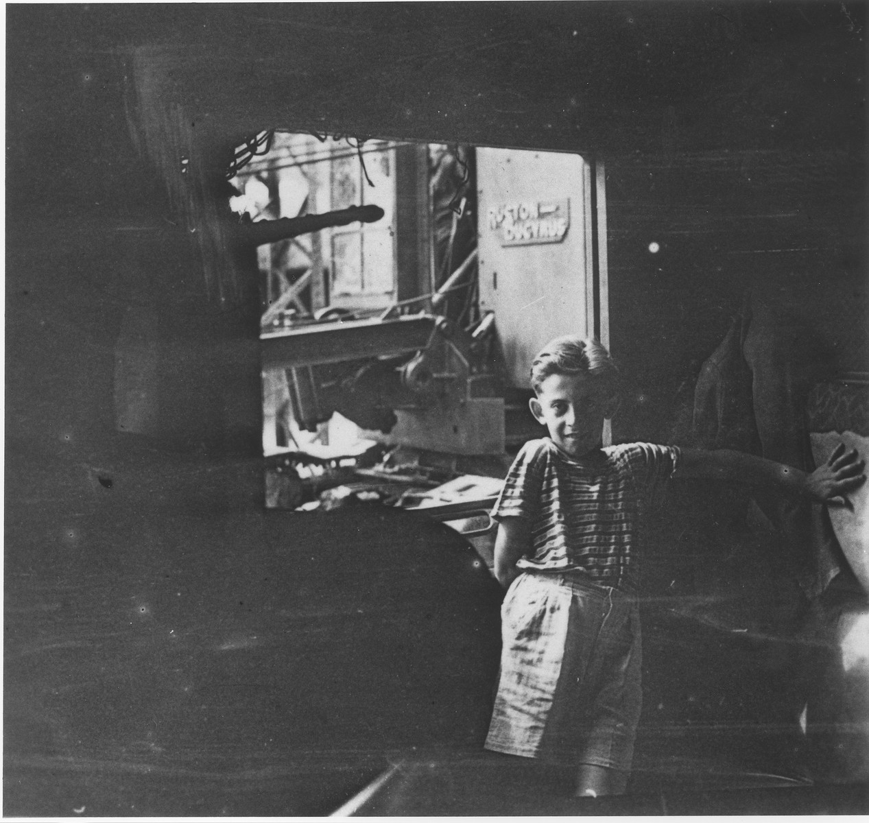 Wolfgang Schaechter poses in a garage in the Enns displaced persons camp.