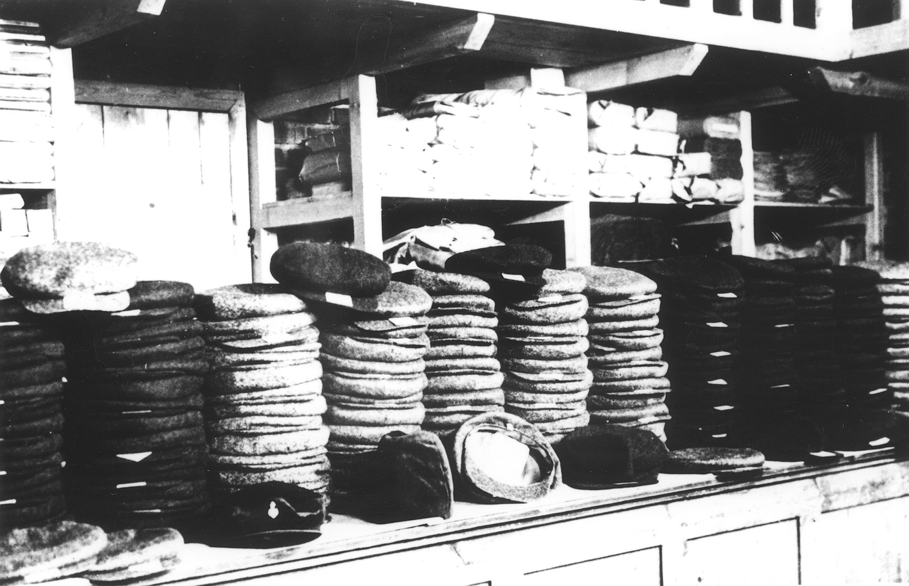Stack of hats piled in a warehouse in the Novaky labor camp