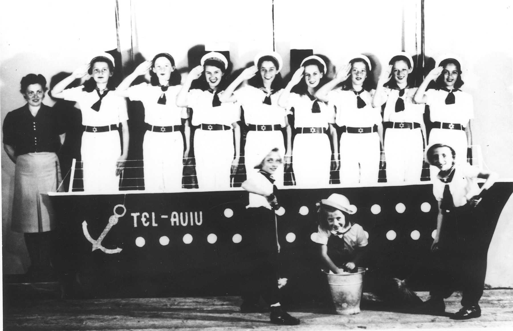Young women dressed as sailors perform a musical in the Novaky labor camp