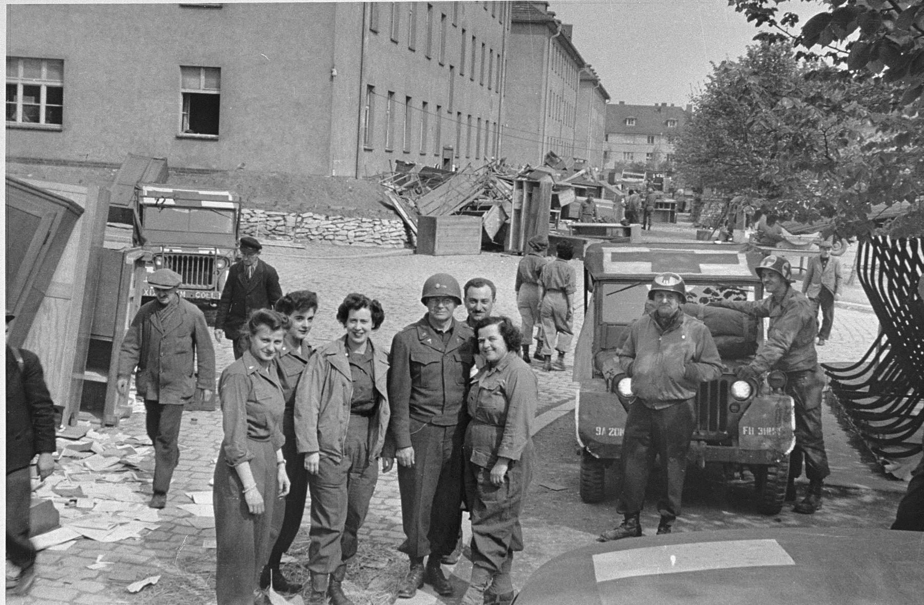 American medical personnel stand in front of a school that has been converted into a hospital for concentration camp survivors from Langenstein-Zwieberge. 

Among those pictured is Francis A. Speer (third from the left, facing the camera).