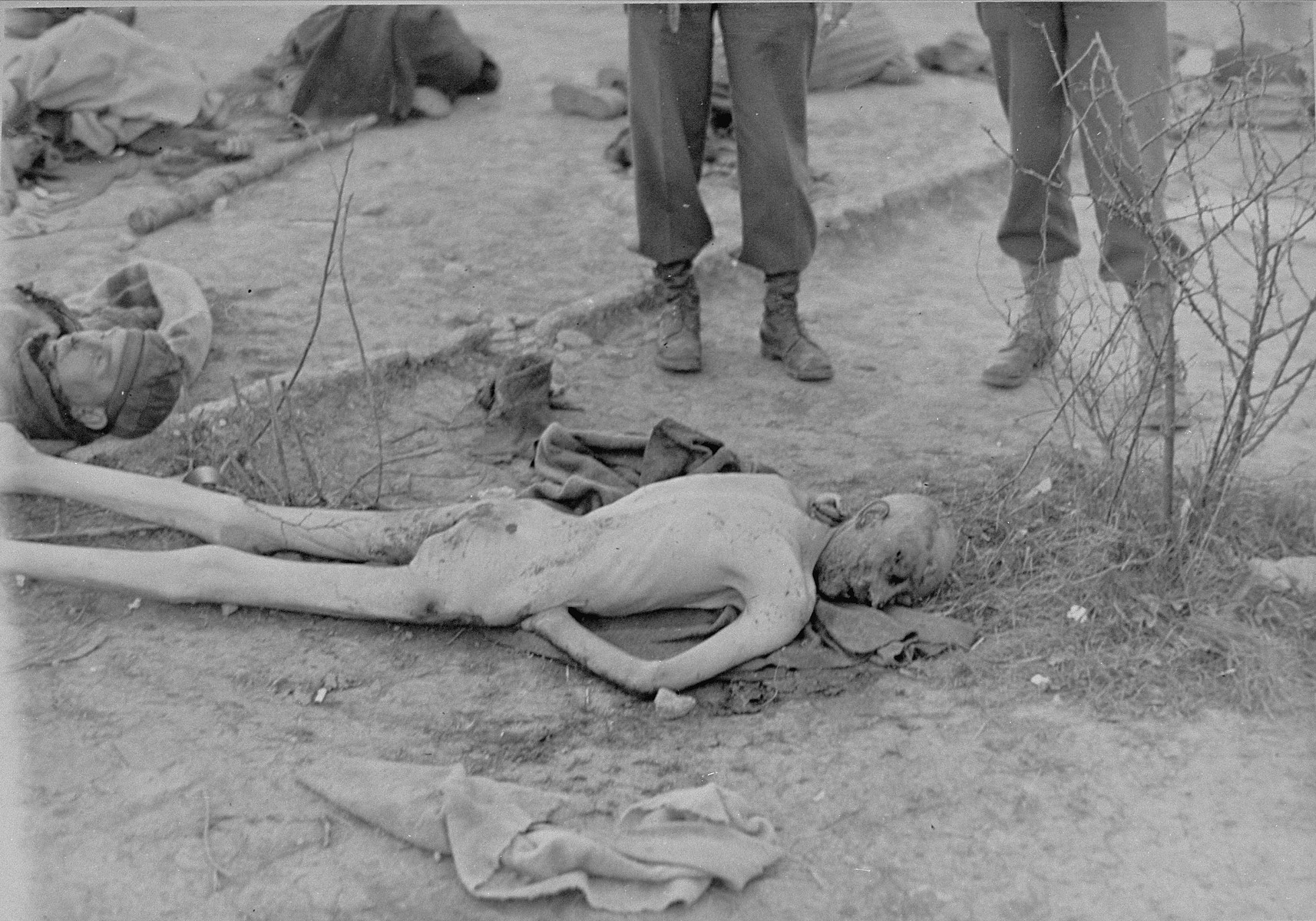 American soldiers view a naked, emaciated corpse in Ohrdruf.