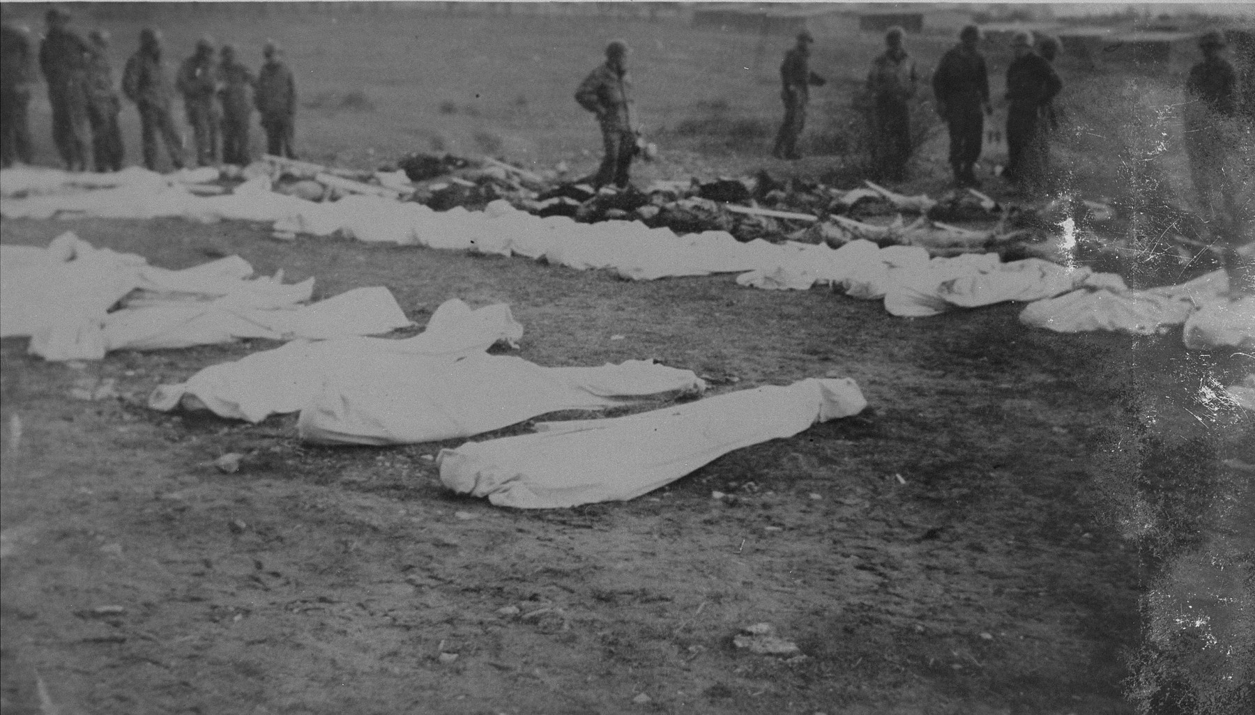 American troops at the burial of corpses found in the Ohrdruf concentration camp.  Each corpse was assigned a numbered grave marker.