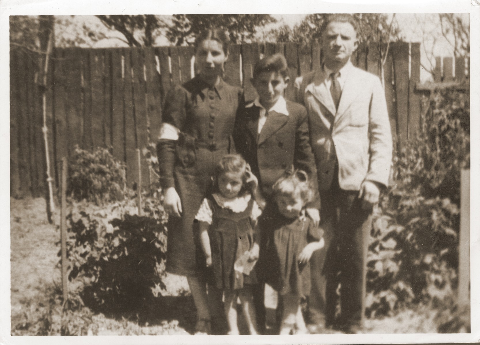Portrait of the Shulman and Rothstein families in the Grodzisk Mazowiecki ghetto.

Pictured in the back row from left to right are: Sura Feiga (Shulman) Rothstein, Luzer Shulman, Abraham Shulman.  In the front row are Chana and Liba Rothstein.