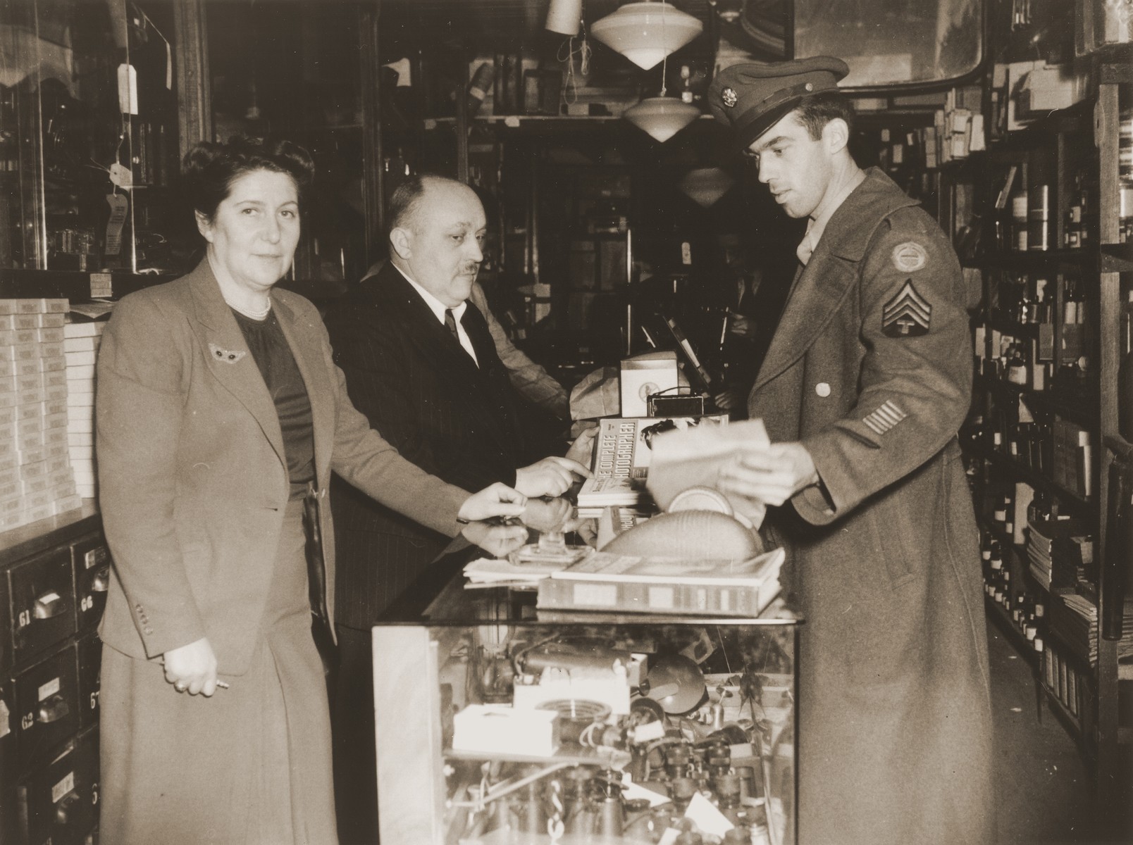 Nelly and Raffael Brenner wait on a soldier in the Brenner Photo company store located on Pennsylvania Avenue in Washington, D.C.