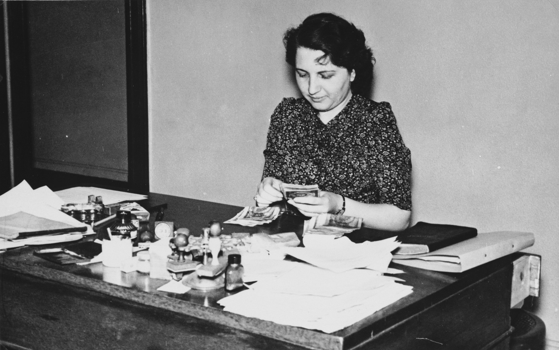 A member of the International Committee for European Immigrants in Shanghai at work in her office at the Cathay Hotel.

One photograph from a second International Committee album prepared for I.C. secretary Paul Komor.
