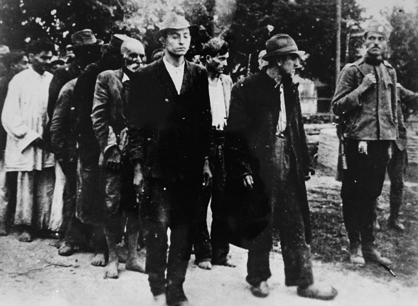 A Serbian gendarme serving the Serbian puppet government led by Milan Nedic, escorts a group of Roma to their execution.