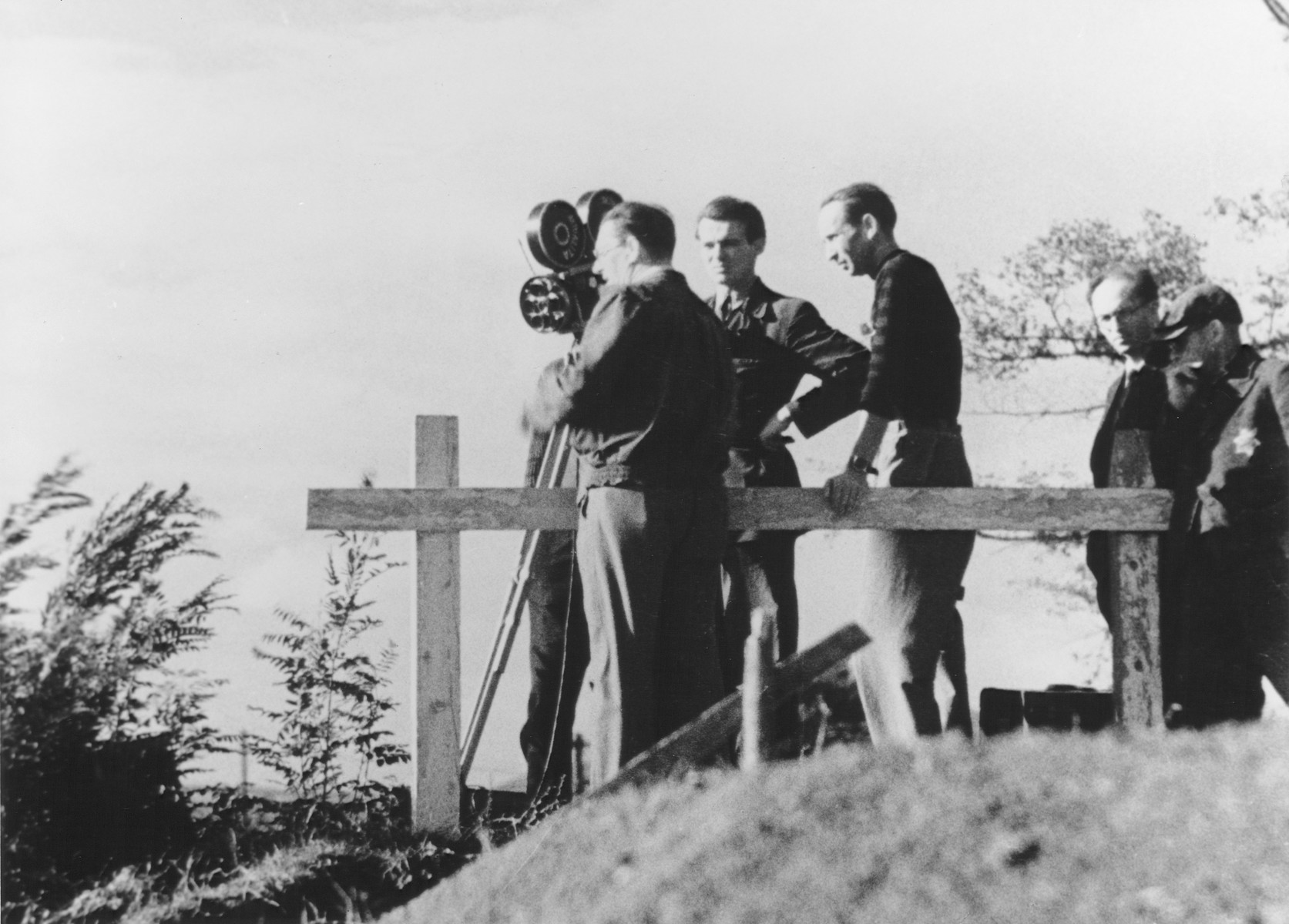 A film crew takes motion pictures in the Theresienstadt ghetto during the filming of  the Nazi propaganda film "Der Fuehrer Schenkt den Juden eine Stadt" [The Fuehrer gives the Jews a City].

Ivan Fric is pictured in the middle of the film crew.