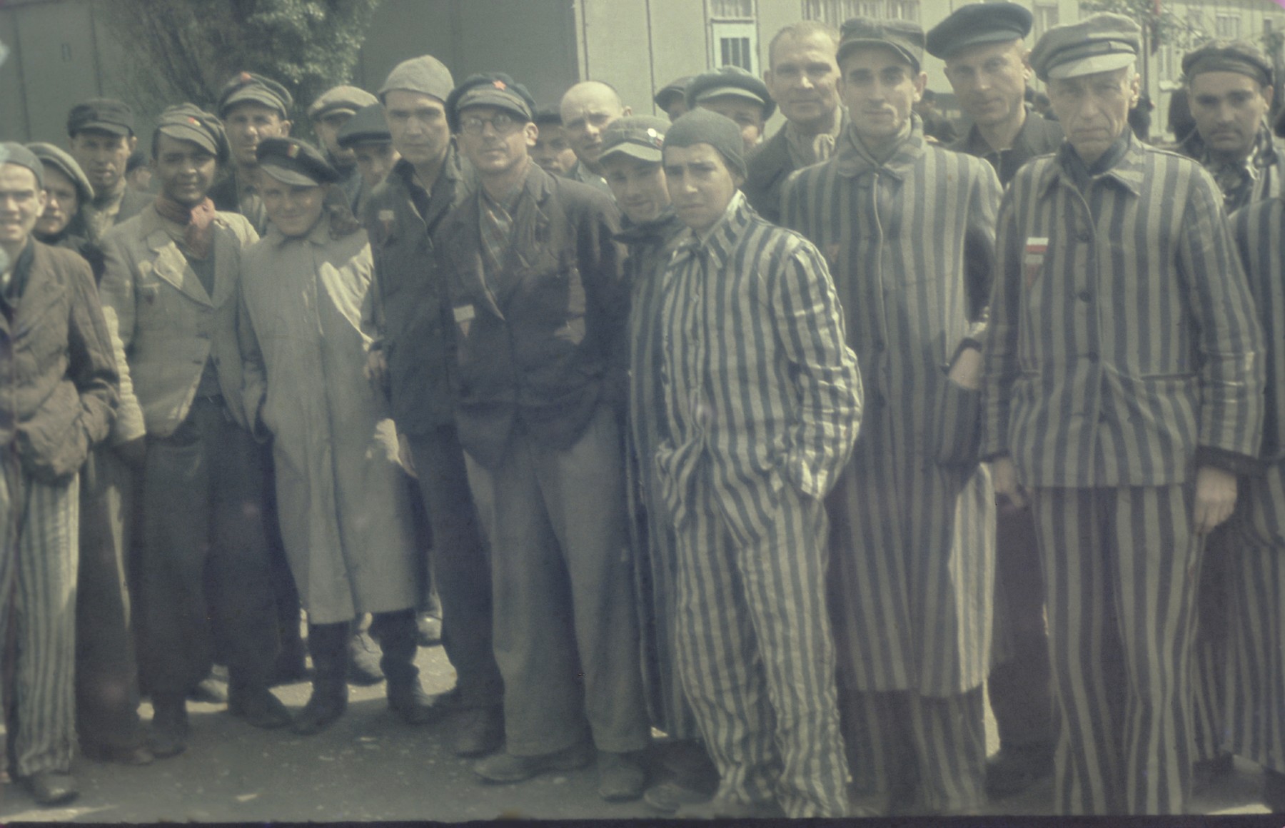 Group portrait of former political prisoners in the newly liberated Dachau concentration camp.

Among those pictured is Johny Voste, wearing a red scarf.
