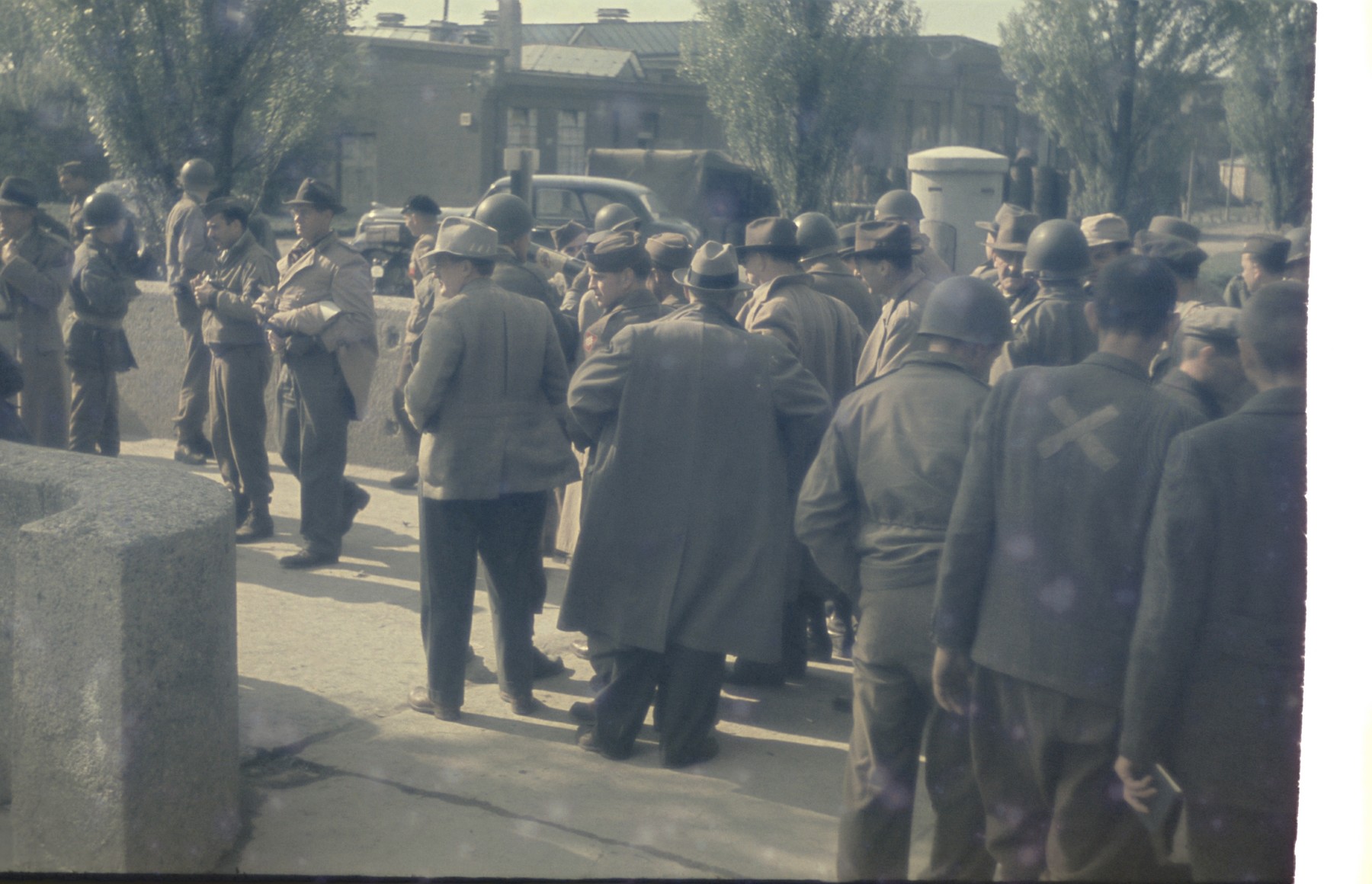 Survivors mingle with American soldiers in the newly liberated Dachau concentration camp.