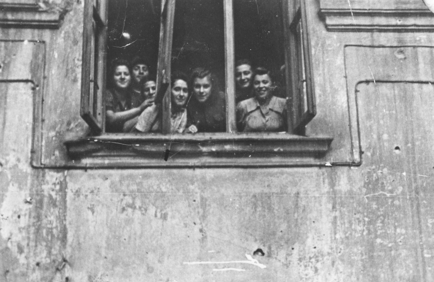 Members of the Kibbutz Ichud hachshara look out of the window of their Warsaw apartment.

Among those pictured are Sara Fiszman, Zosia, Hela Iwaniska, Hanka and Morris.