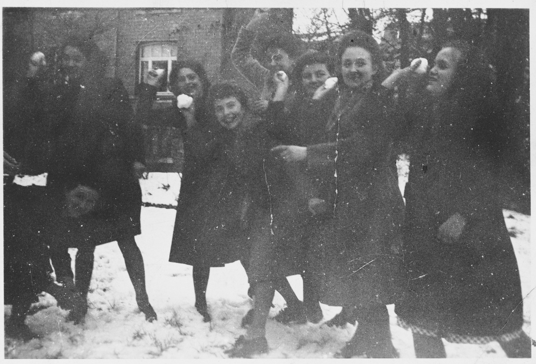 A group of Jewish girls who are living in hiding in Belgium, play in the snow.