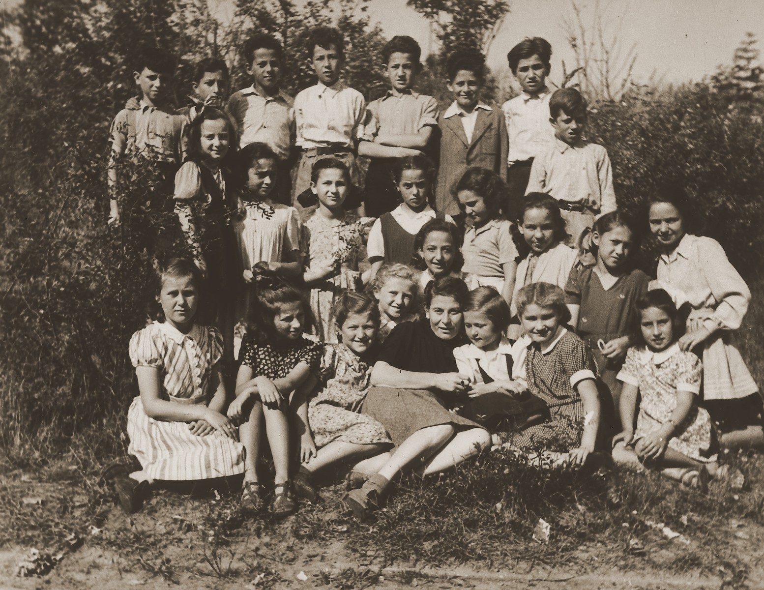 Sima Portnoy, a teacher at the Schlachtensee displaced persons camp, poses with her students outside.