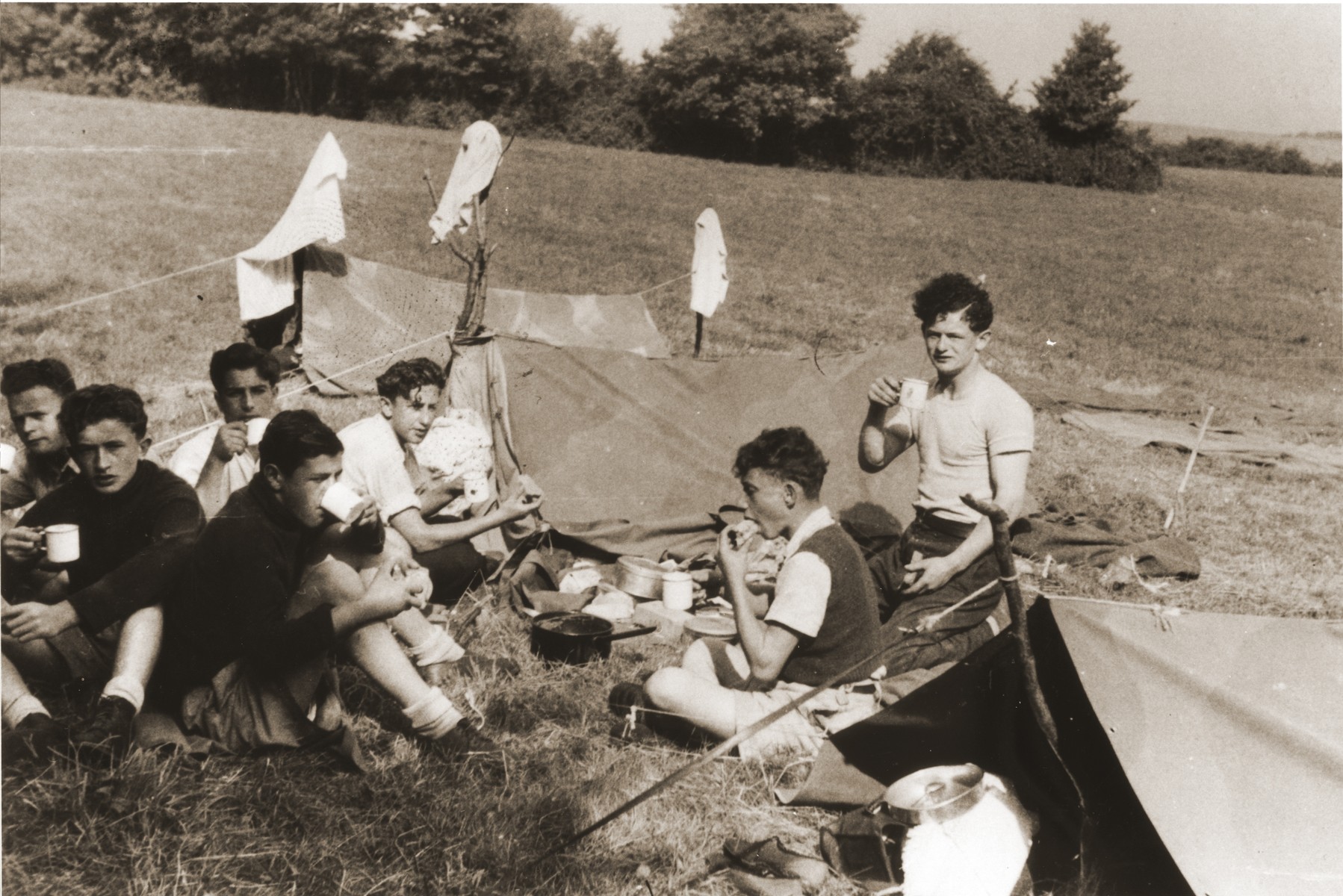 Members of the orphans transport to England go camping on the Isle of Wight.

Among those pictured are Paul Gast (center), Szlomo Kuszerman (second from the right) and Moniek Goldberg (right).