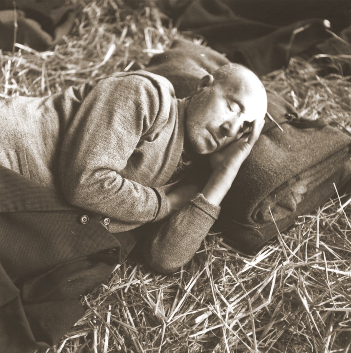 A elderly Jewish man rescued from Theresienstadt rests on a bed of straw in the Hadwigschulhaus in St. Gallen.