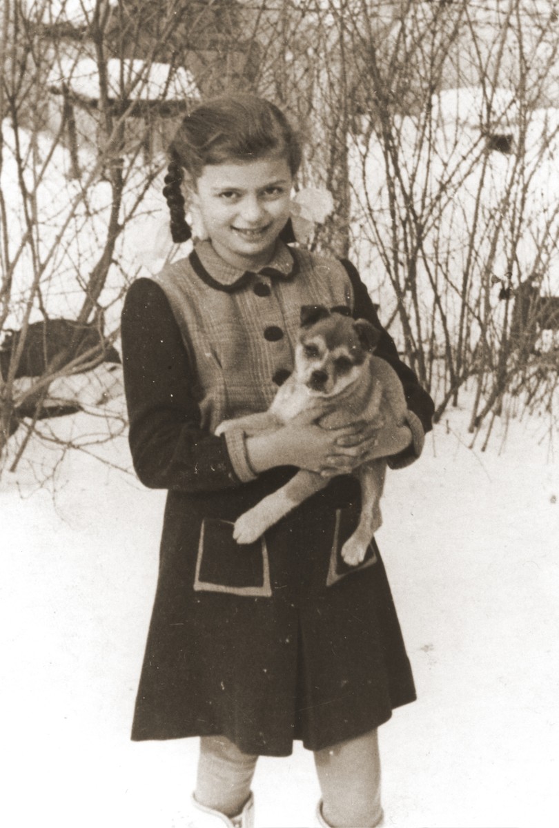 Erika Vermes clutches her puppy while standing in the snow.