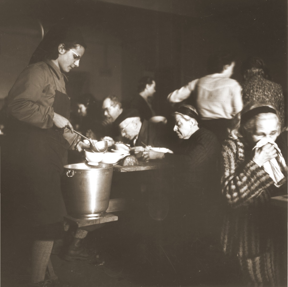 Swiss Red Cross workers distribute food to elderly Jews rescued from Theresienstadt in the Hadwigschulhaus in St. Gallen.