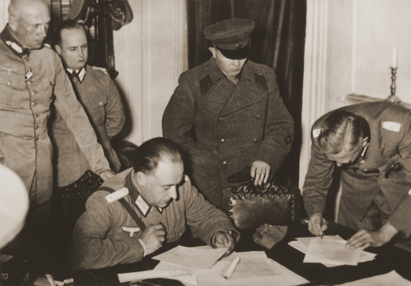 German and Soviet military officers sign the agreement by which Poland is partitioned between Germany and the Soviet Union.

Original caption from Corbis-Bettmann reads:  "A scene in the government building here as German (left) and Soviet (right) army officers divided Poland into two sections.  A demarcation line cut the country from North to South, with Germany occupying the territory west of the line, and Russia the east."