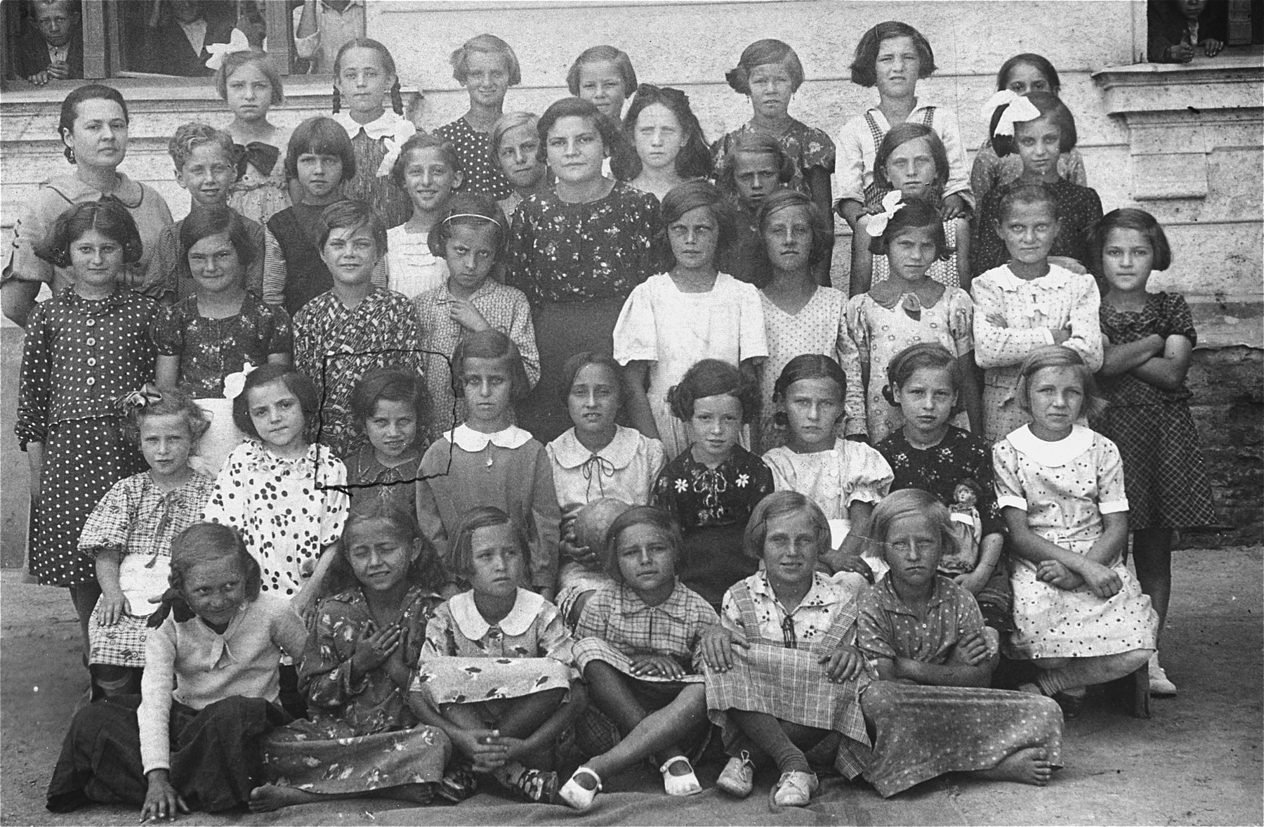 Group portrait of first grade students and teachers at a public school in Vinogradov, Ukraine.  

Among those pictured is 6-year-old Edith Rottenstein (second row, third from the left).  Edith survived the Auschwitz and Stutthof concentration camps.