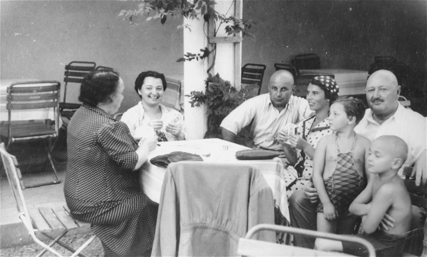 The Muller and Herzog families play cards at a resort hotel in Czechoslovakia.

Pictured at the far left are Lilly Herzog and the donor, Magda Herzog Muller; at the far right is Jakub Herzog with his two grandchildren, Alice and Heinrich.