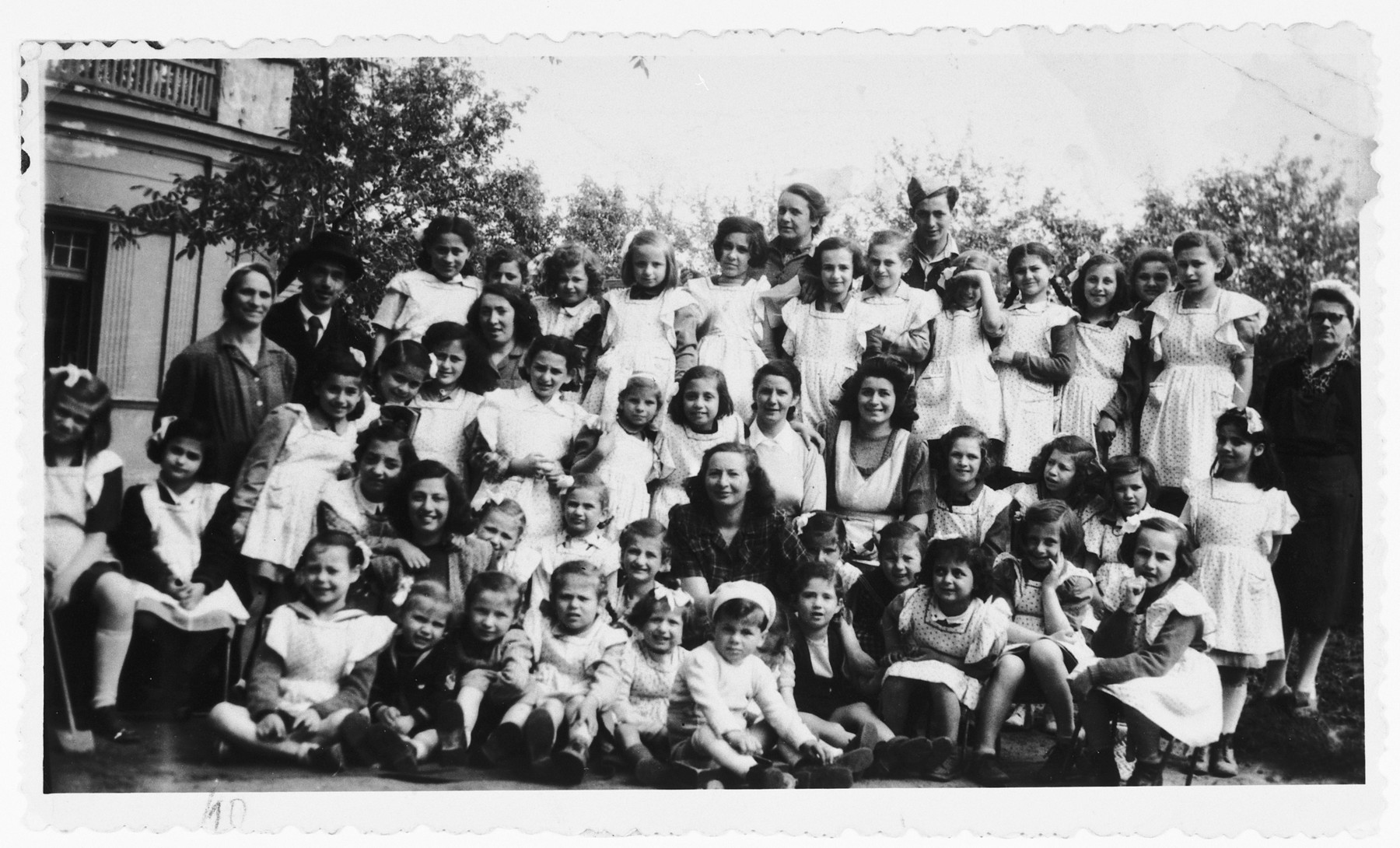 Zsofi Brunn (back row, center) poses with the orphans under her care in a JDC sponsored orphanage outside of Budapest.

Zsofi Brunn directed this orphanage from 1946 to 1948.  The children were retrieved from hiding from the JDC, and Zsofi worked with the Zionist underground to bring the children to Israel.  In 1948 an informant told the governmnet about her activities, and she had to flee to Germany.