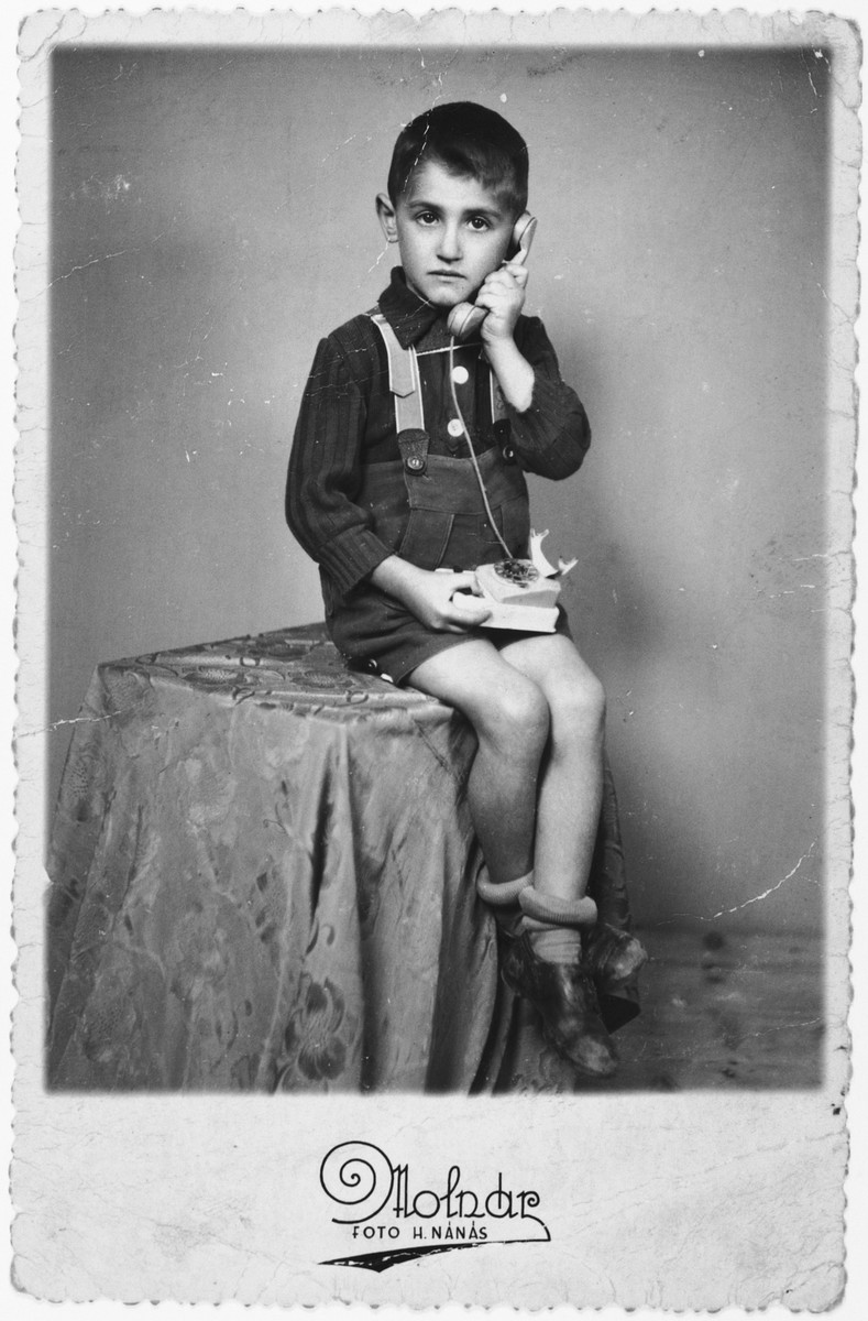 Laszlo Ornstein poses for a studio portrait with a telephone less than two years before he was killed in Auschwitz.

The original caption, addressed to his father who was interned in a forced labor camp, reads "I had called you, dear father to let you know that your children are waiting for you together with Jutka and Lacika".