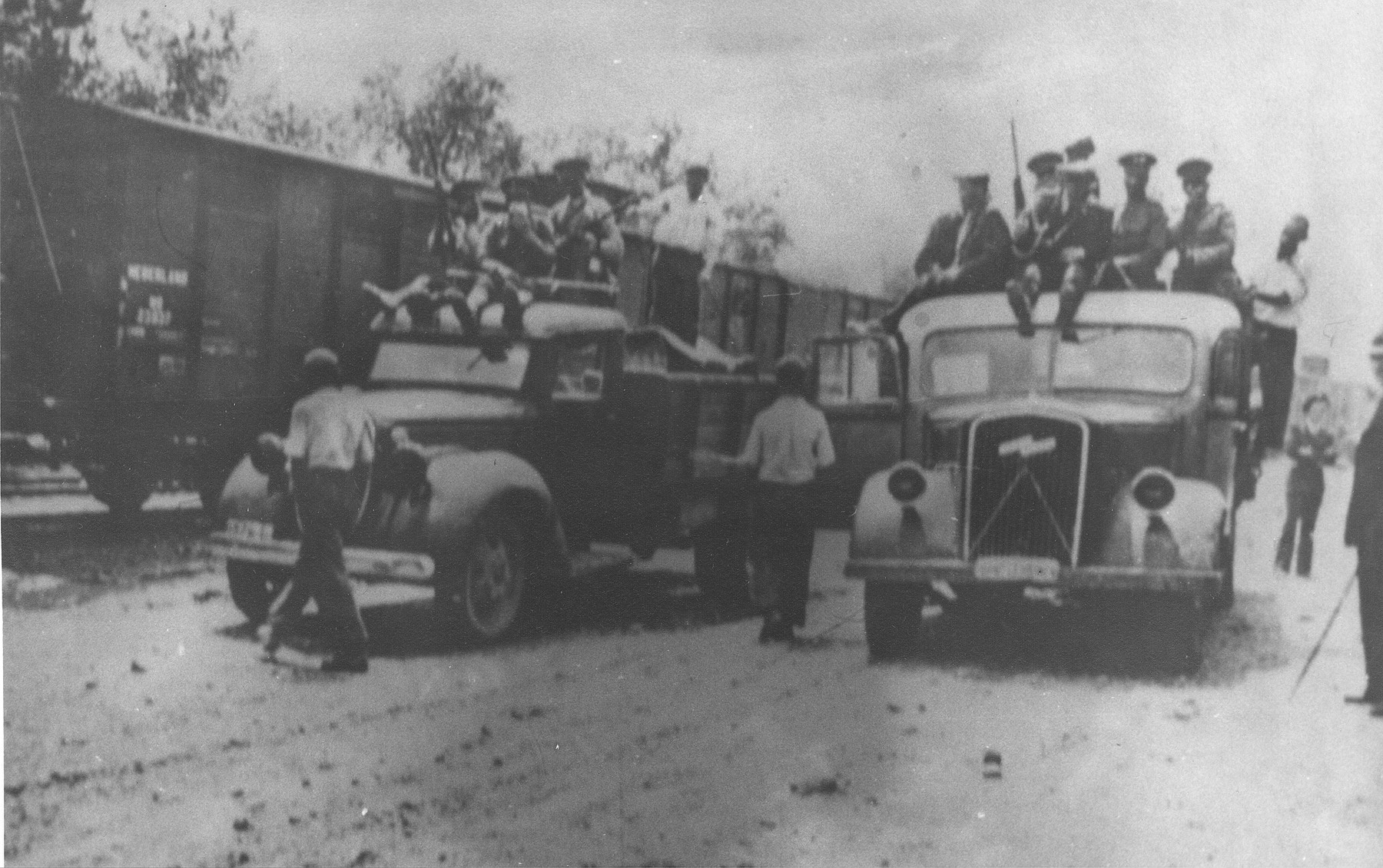 Romanian guards in trucks arrive in Targu-Frumos, where the Iasi-Calarasi death train is making a stop on its journey.