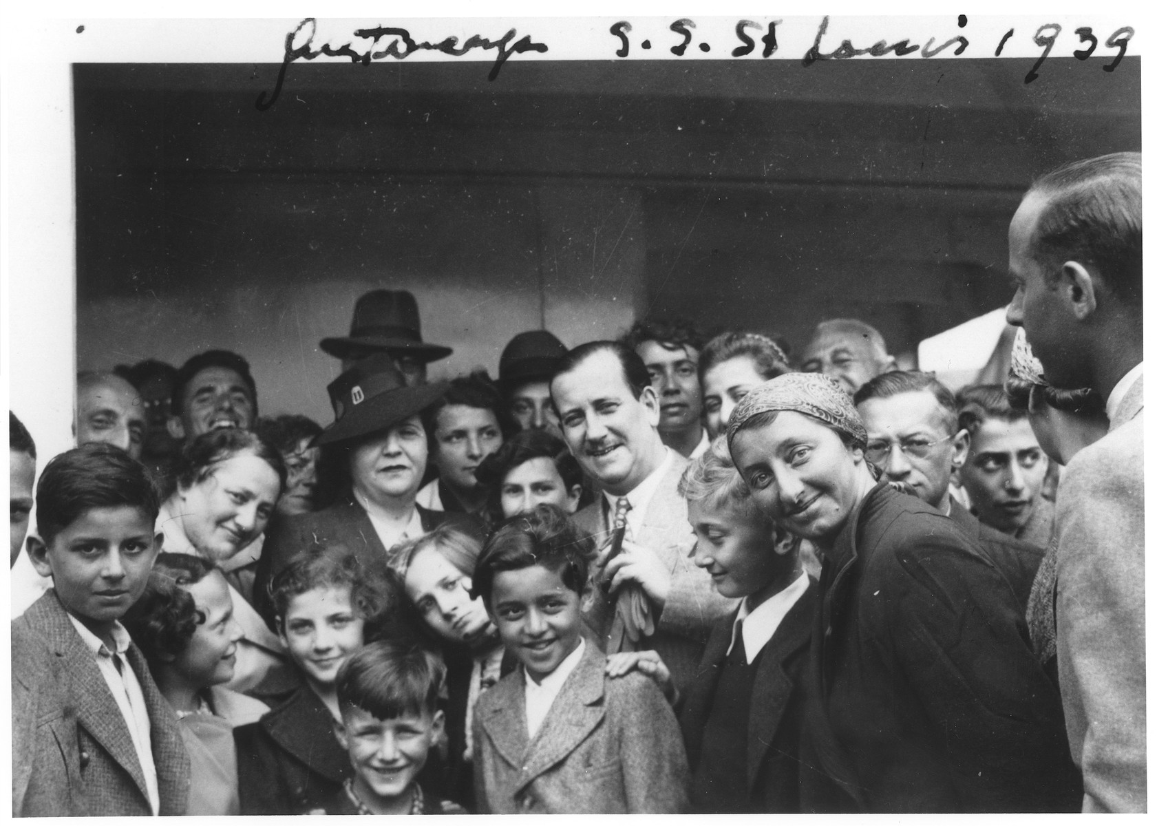 Mr. and Mrs. Morris Troper (center) pose with Jewish refugees on the deck of the MS St. Louis in the port of Antwerp.  

Also pictured are Liesel Joseph, Ruth Karliner, Heinz Gallant and Windmueller.