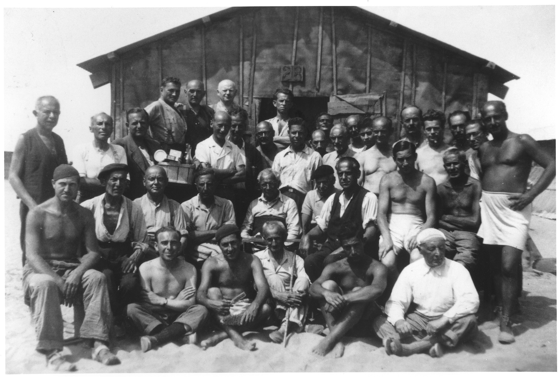 A group of male prisoners poses outside barrack no. 28 in the Saint Cyprien internment camp.

The man in the top row, second from the right is Moritz Adler.