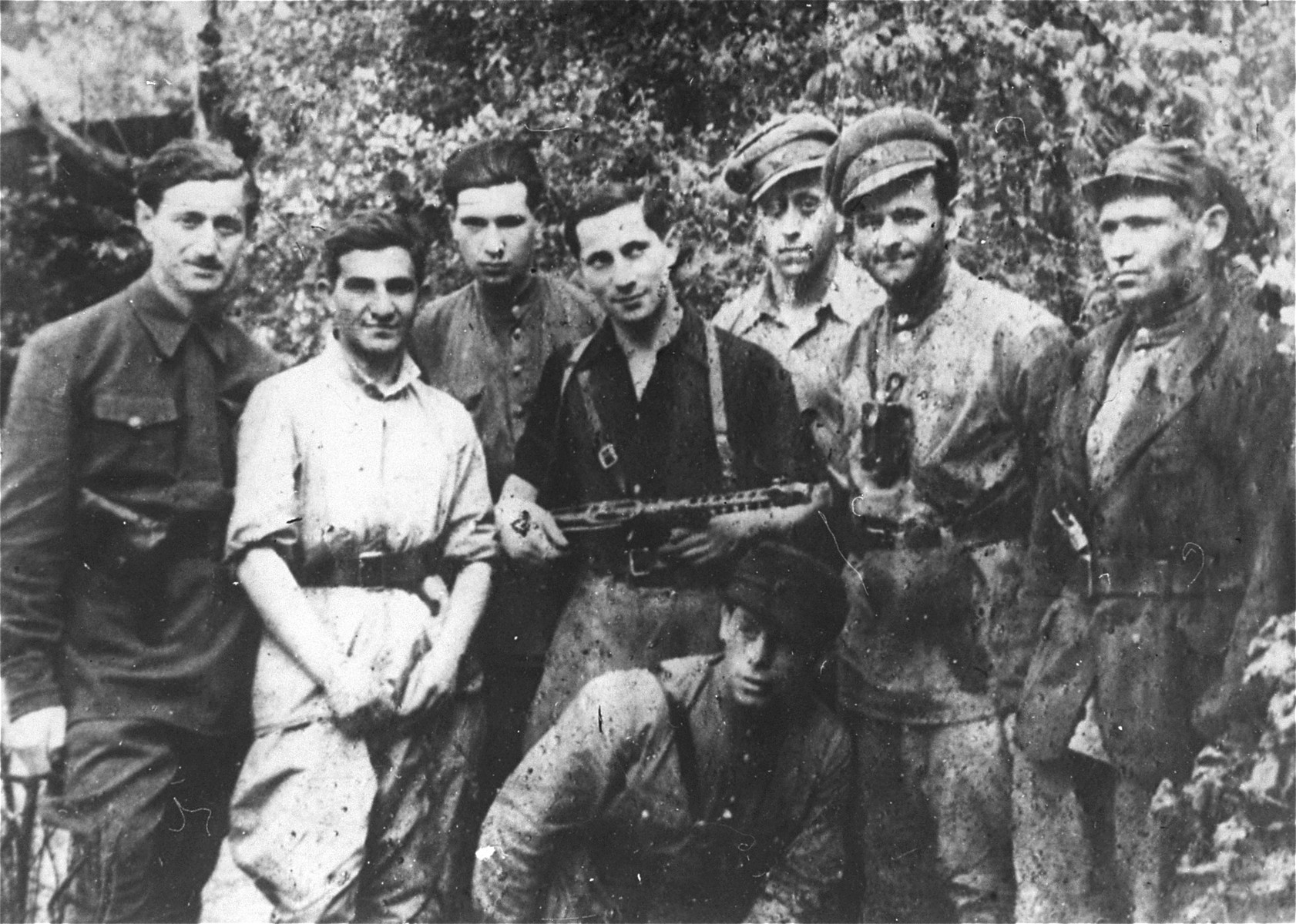 Jewish partisans with the Korchagin battalion in the forests of Lithuania.  

The man at left is Rachi Ben-Eliezer.  [Berel Kot may be standing third from the left.]