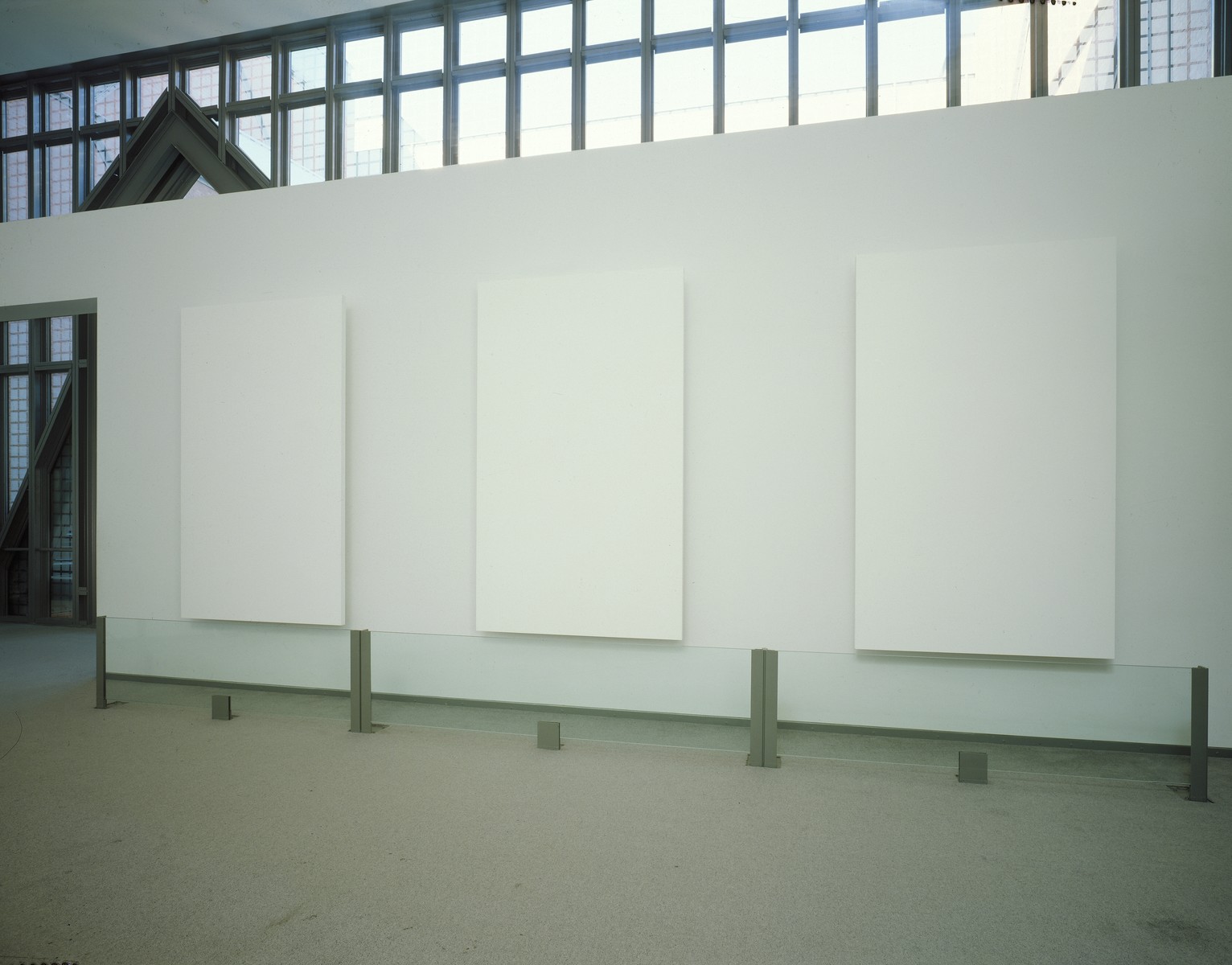 A wall sculpture entitled "Memorial" by Ellsworth Kelly, displayed in the permanent exhibition of the U.S. Holocaust Memorial Museum in the lounge space between the third and fourth floors. These three paintings along with a fourth comprise the entire work.
