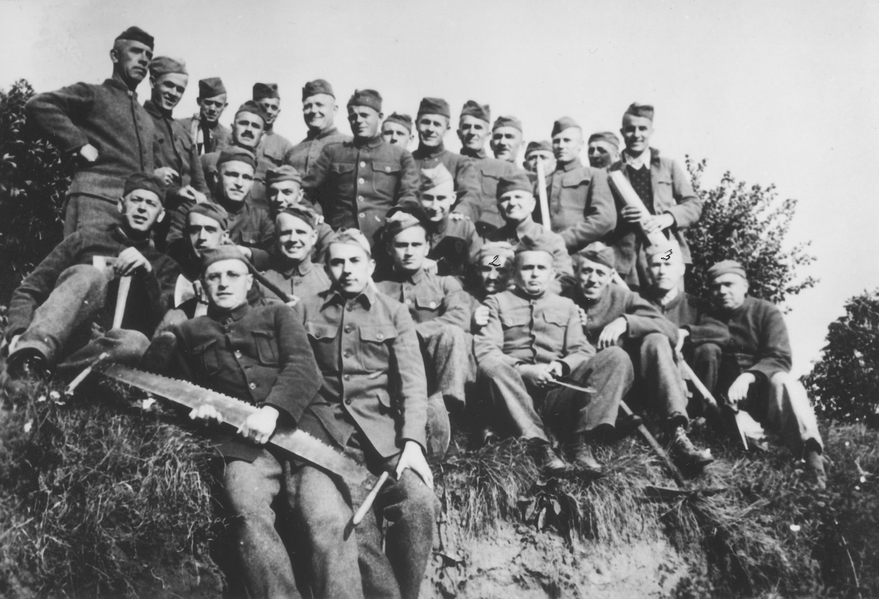 Group portrait of Czech political prisoners interned in Theresienstadt who were put to work felling trees.

Among those pictured is Oskar Bartolsic.