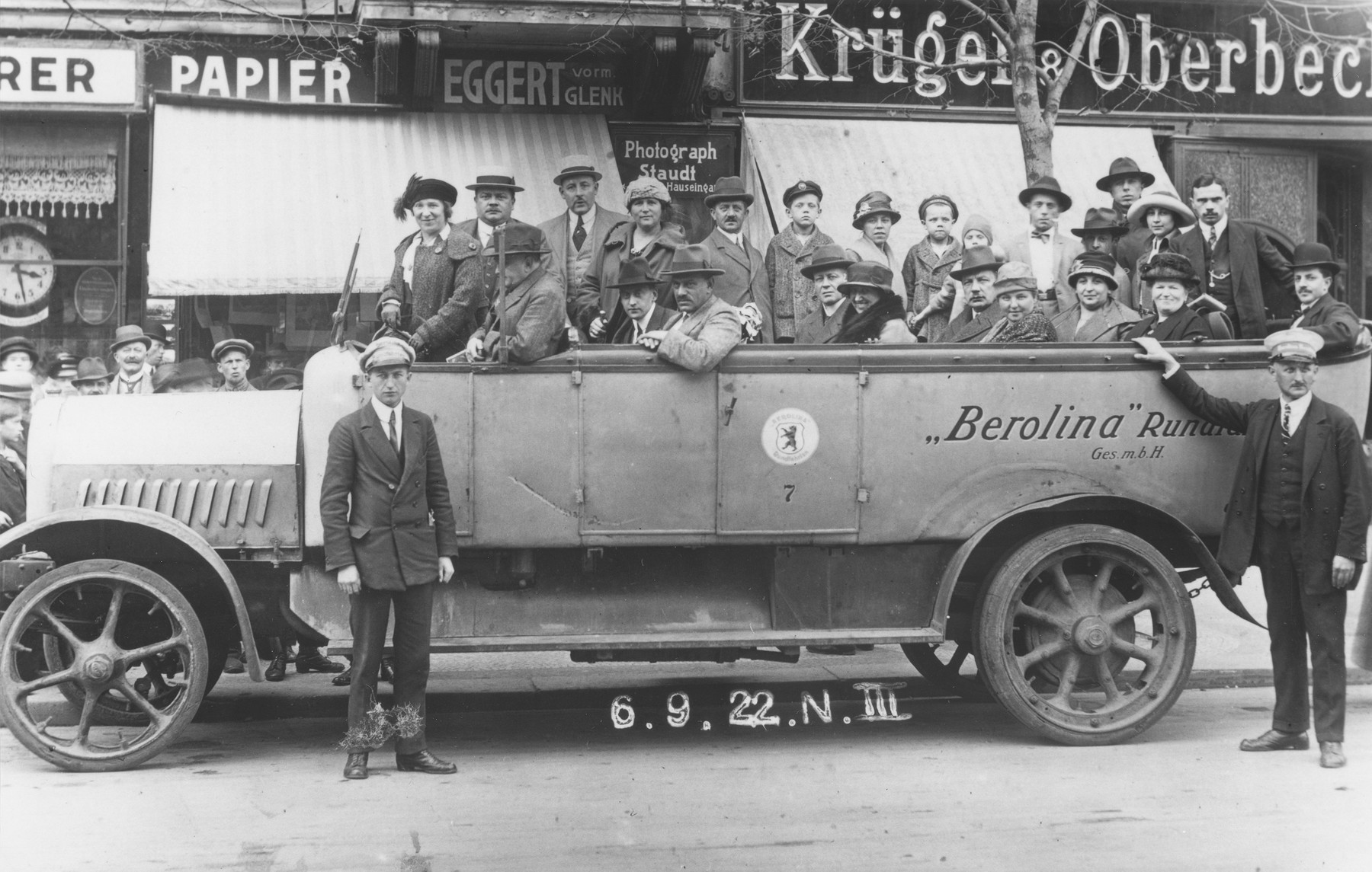 Dr. Adolf Huber and his wife, Paula (Knopfmacher) Huber, ride in the back of an open bus during a tour of Berlin.

The couple is pictured in the center of the vehicle behind the coor with the seal.