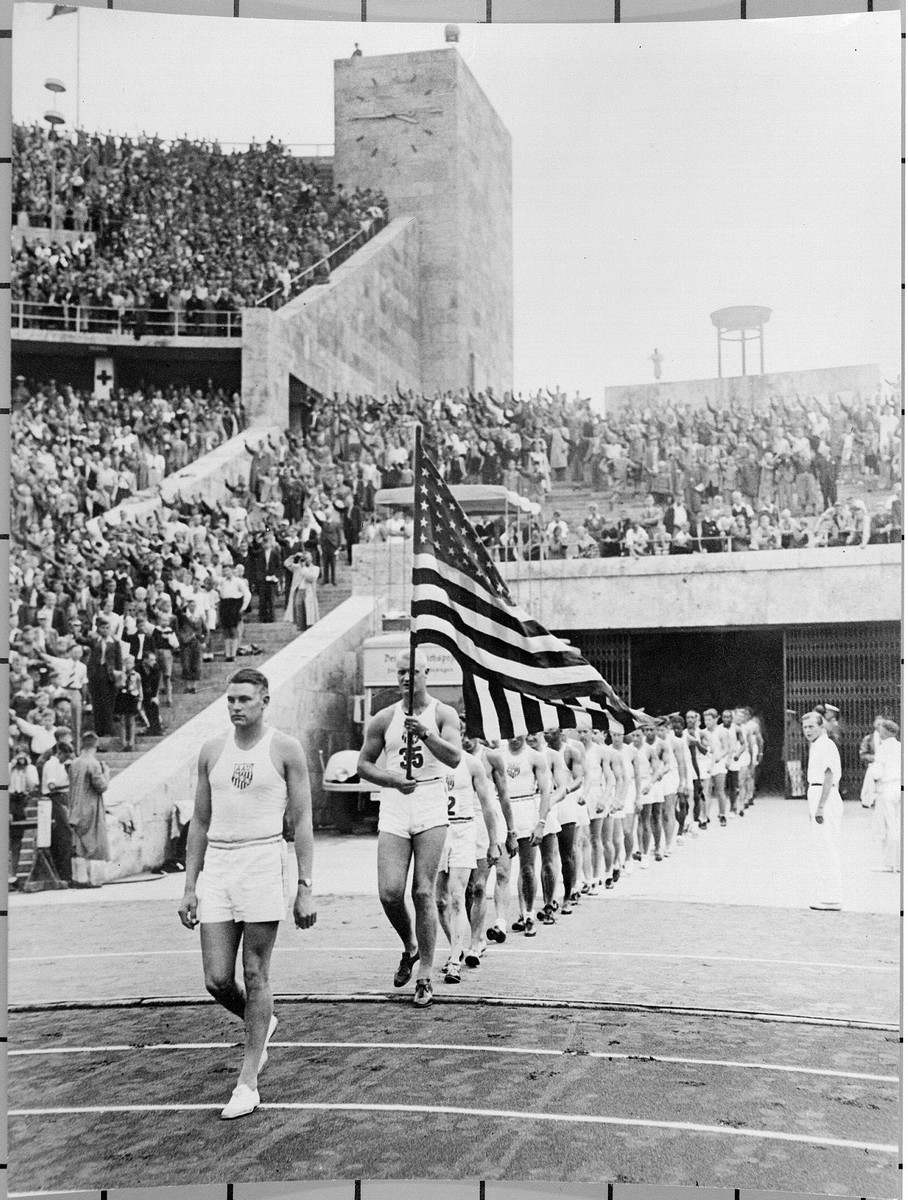 American athletes, participating in a United States-German friendship track and field competition, march onto the field at the Olympic stadium in Berlin.  The competition was sponsored by Avery Brundage and the U.S. Olympic Committee.