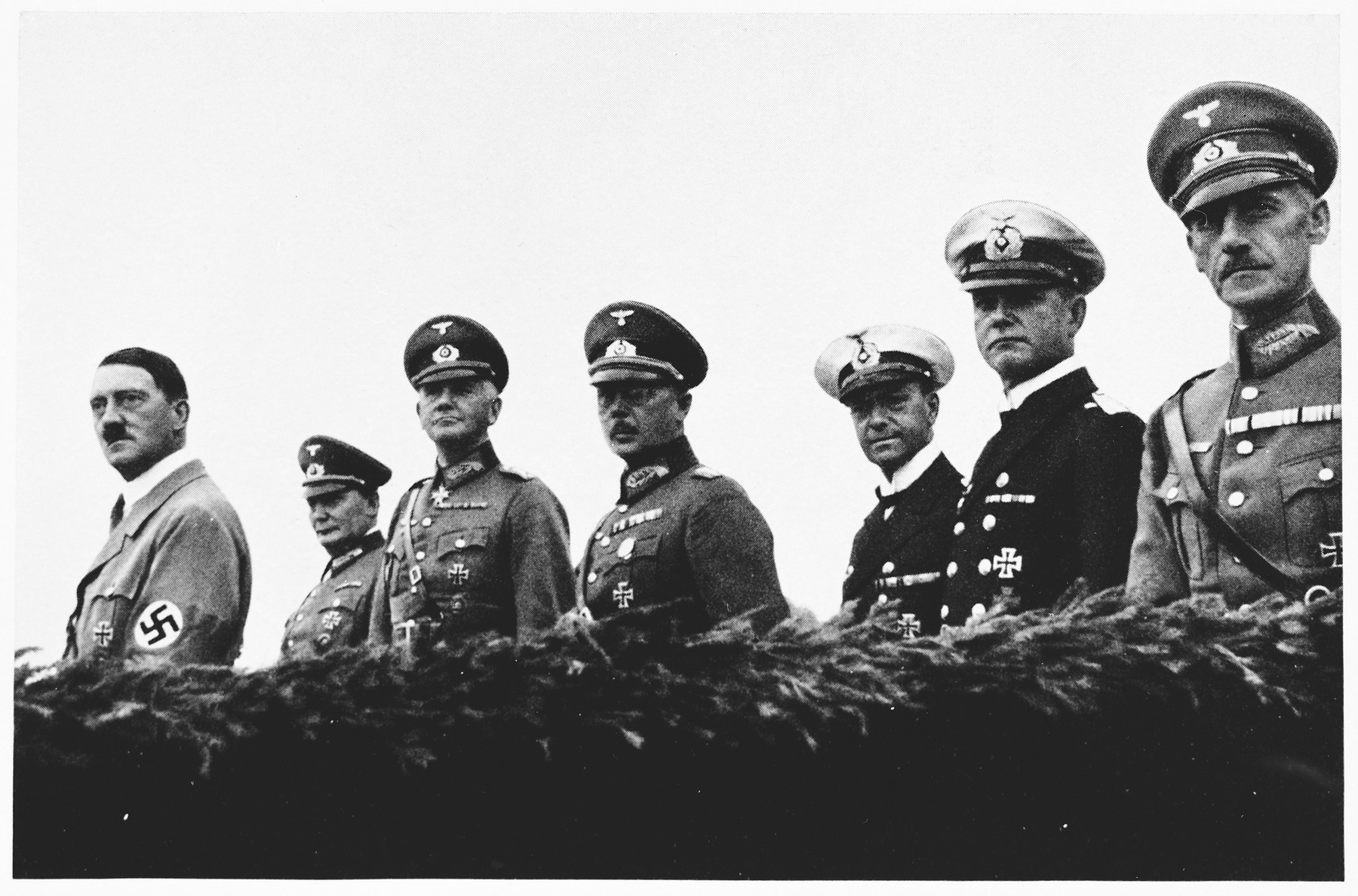 Hitler poses with members of the High Command during Wehrmacht Day celebrations. 

Pictured from left to right are: Hitler, Hermann Goering, Werner von Blomberg, Werner von Fritsch, and Erich Raeder.