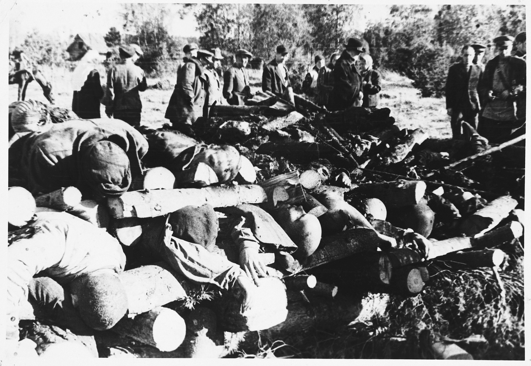 Soviet soldiers observe recently burned corpses on the grounds of the Klooga concentration camp.