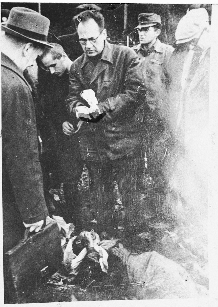 Soviet liberators witness burned corpses lying on the grounds of the Klooga concentration camp.