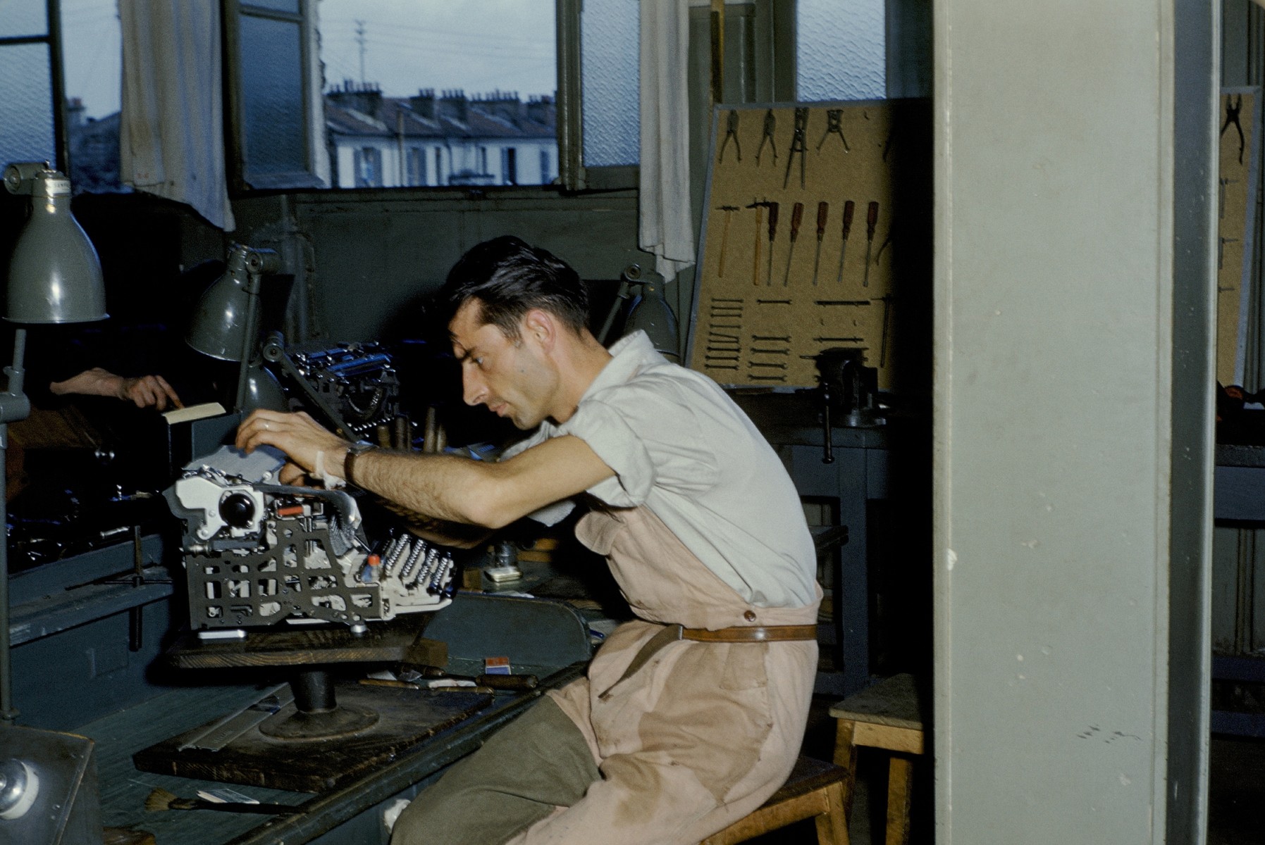 A Jewish DP learns how to repair typewriters in an ORT workshop in an unidentified DP camp.