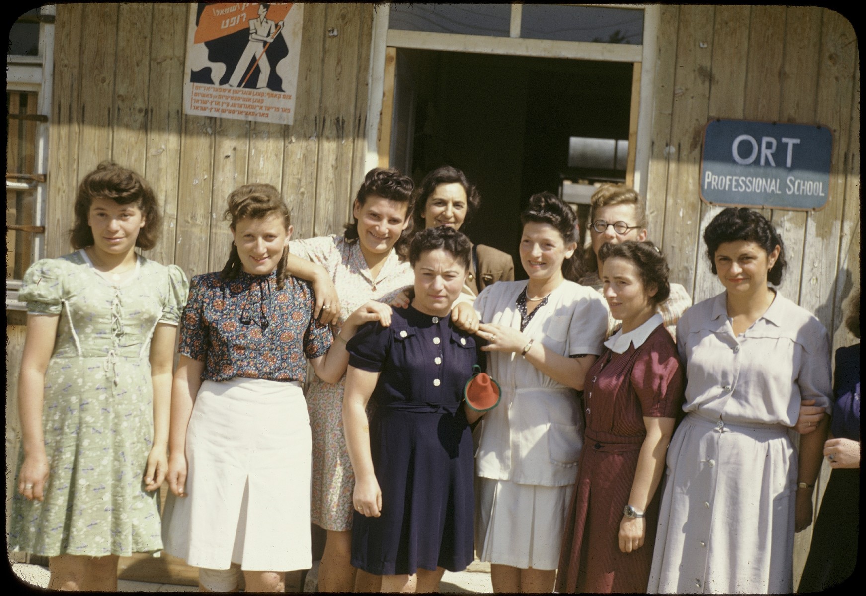 Group portrait of Jewish women standing outside the ORT school in the Feldafing displaced persons camp.

Among those pictured is Judit Ginsburg (first woman on the right).