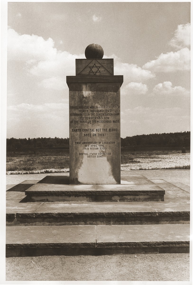 View of the monument erected in Bergen-Belsen on the first anniversary of the liberation of the camp.  

The English text on the monument reads:  "Israel and the world shall remember thirty thousand Jews exterminated in the concentration camp of Bergen-Belsen at the hands of the murderous Nazis.  Earth conceal not the blood shed on thee!  First anniversary of liberation 15 April 1946.  Central jewish Committee British Zone."