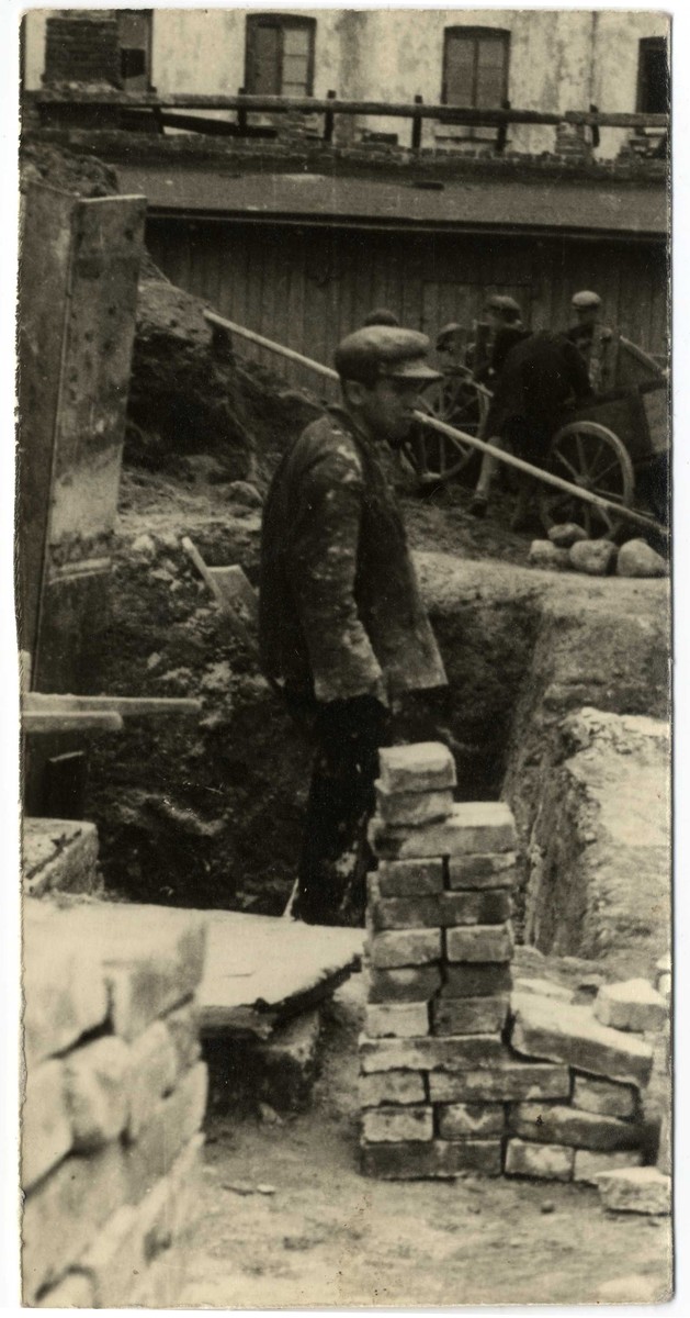 A worker lays bricks in a construction site in the Lodz ghetto.