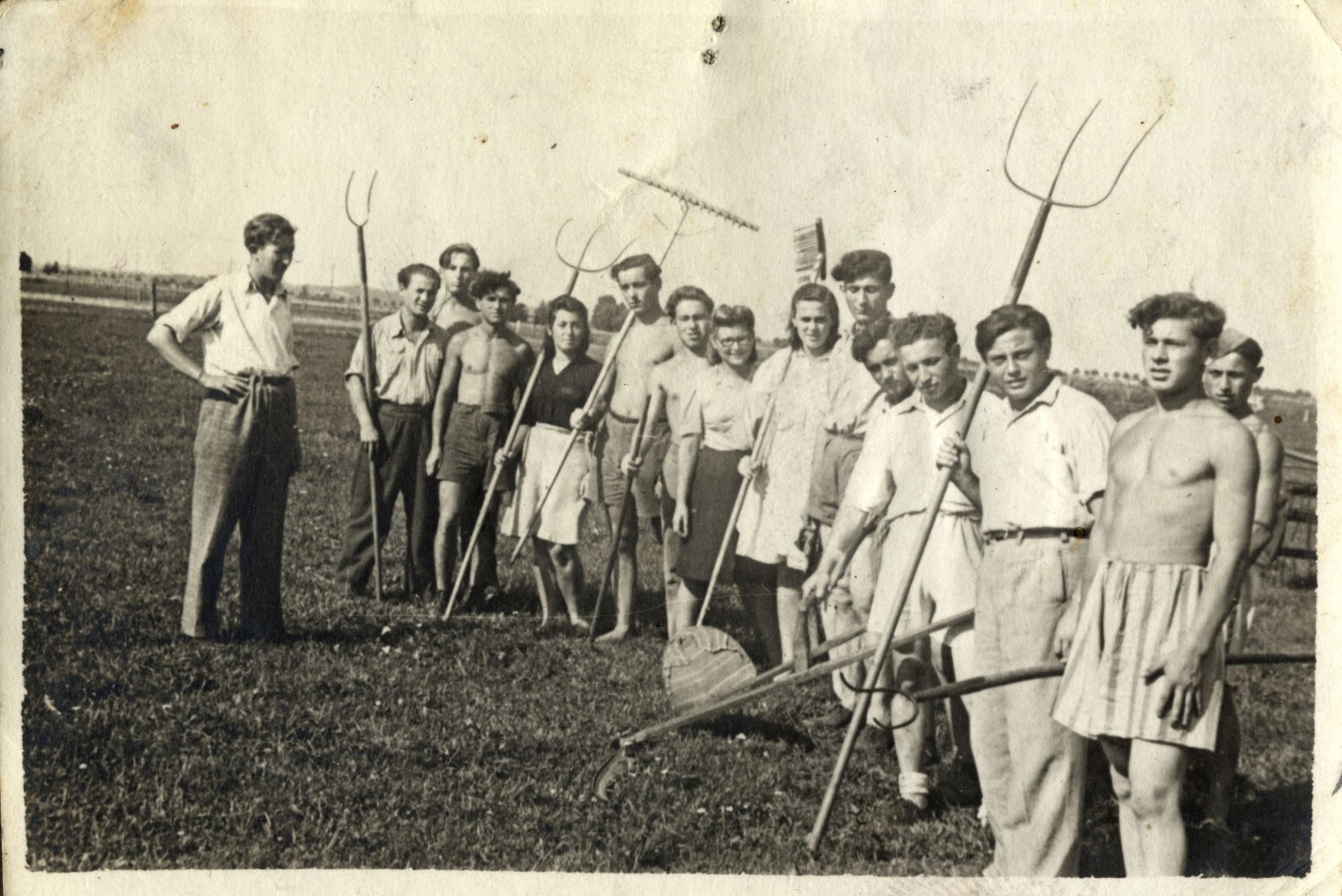 Group portrait of Jewish youth holding farming tools in a kibbutz hachshara in Germany.  

Standing on the far left is probably the donor, Henryk Bergman.