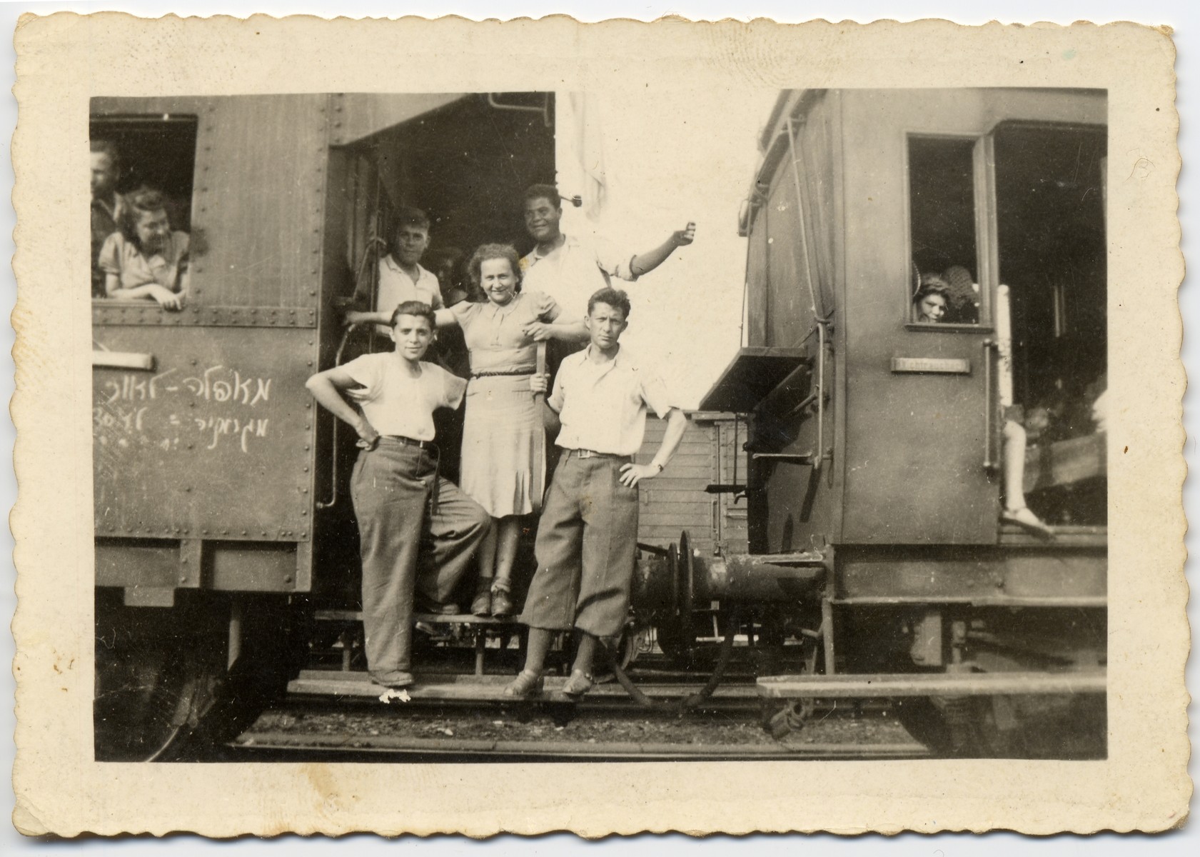 Jewish youth on a train taking them from Germany to Belgium.  The sign on the train reads in Hebrew: "From darkness to light; from Germany to Eretz Israel."

Among those pictured are the donor (on the left, first row) and Hela Schupper Rufeisen in the middle.