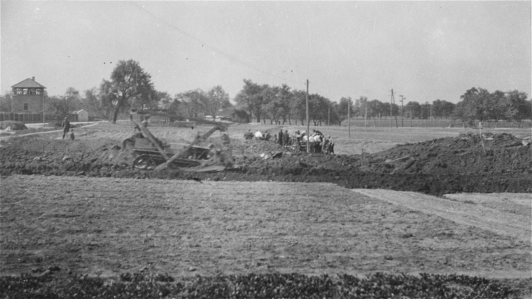 View of Austrian civilians preparing mass graves to bury former inmates in the Gusen concentration camp.