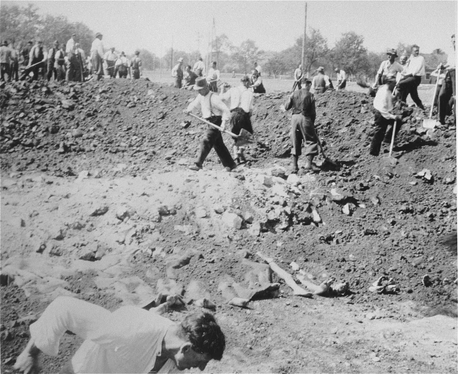 Austrian civilians prepare a mass grave to bury the bodies of former inmates in the Gusen concentration camp.
